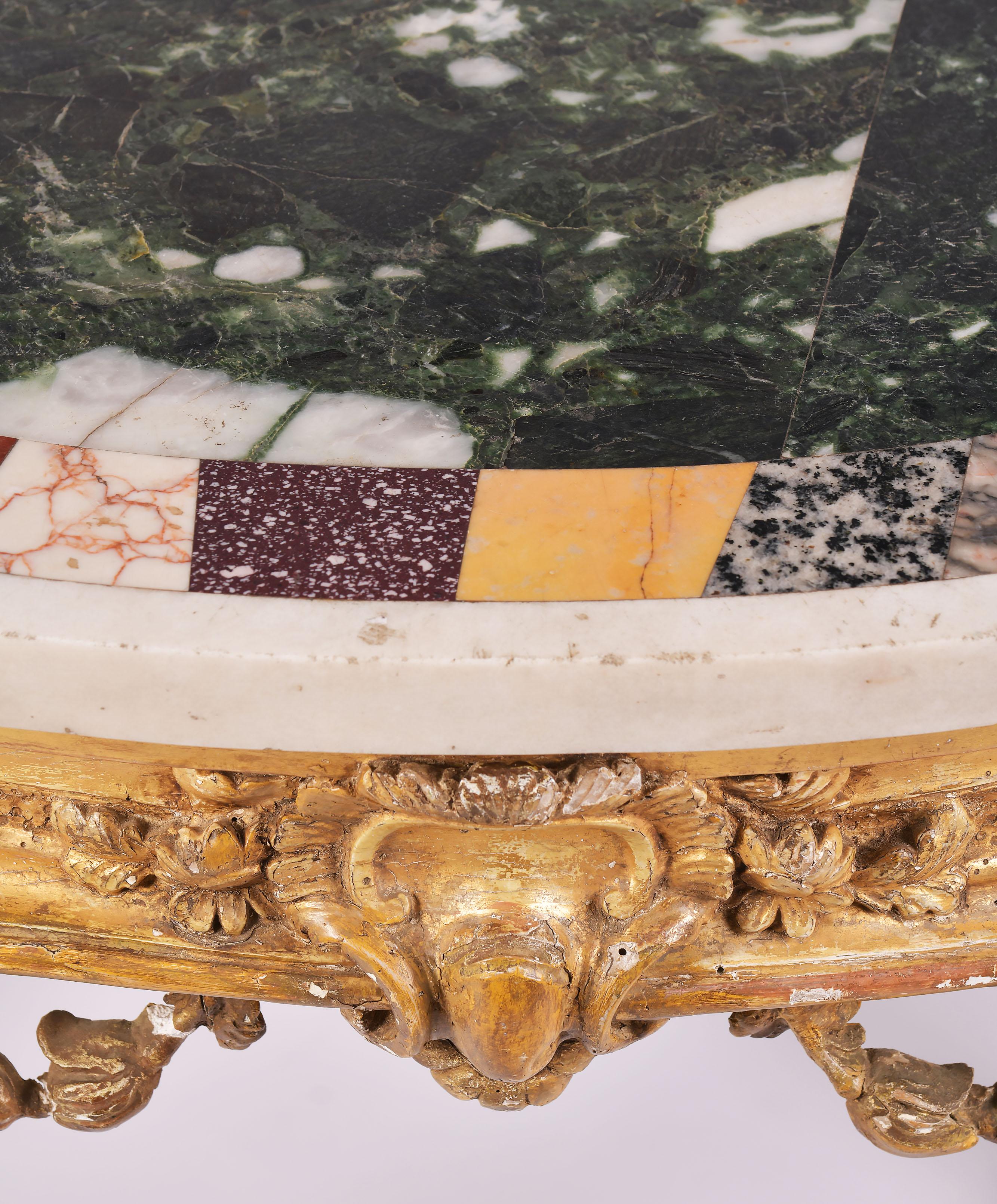 This stunning 18th century carved giltwood console table features a shaped specimen marble top with detailed cabriole legs on curled feet. The table measures 40 in – 101.5 cm wide, 23 5/8 in – 60 cm deep and 32 ¾ in – 83 cm in height. This table