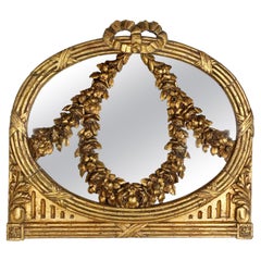 Specchio con volute floreali in legno dorato intagliato del XVIII secolo