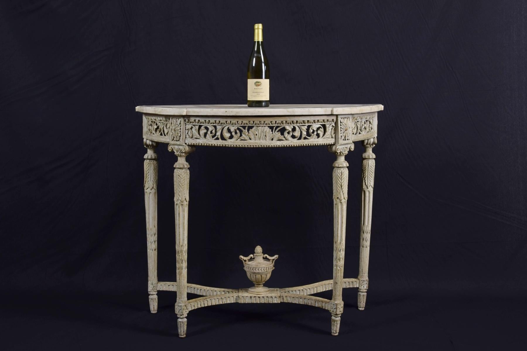 18th century carved and perforated lacquered wood half-moon French console table with marble top

The fine console table was made in France in the 18th century, Louis XVI, in finely carved and lacquered wood, in light tones. It consists of a