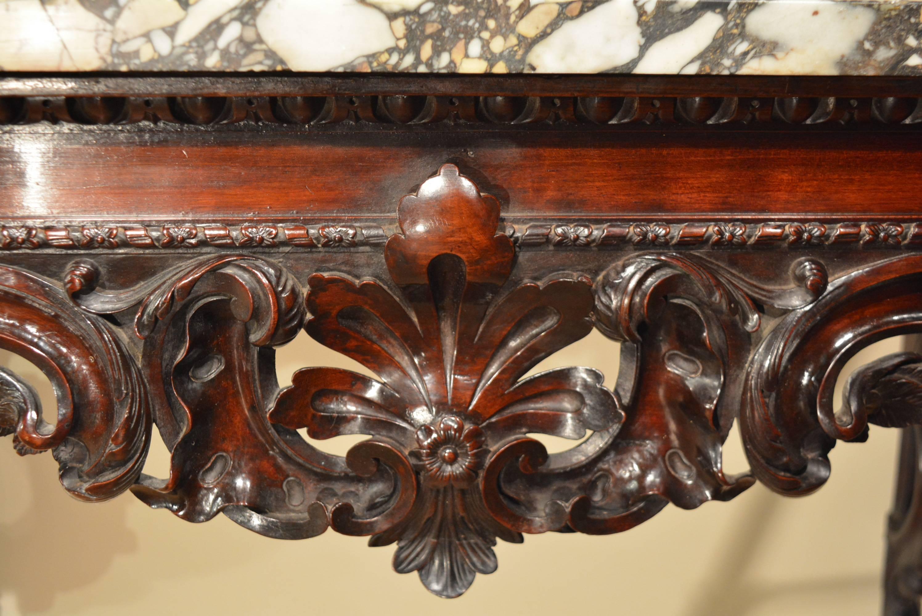 A rare George II carved mahogany marble top console table, the base showing strong auricular influence to the carving.
 