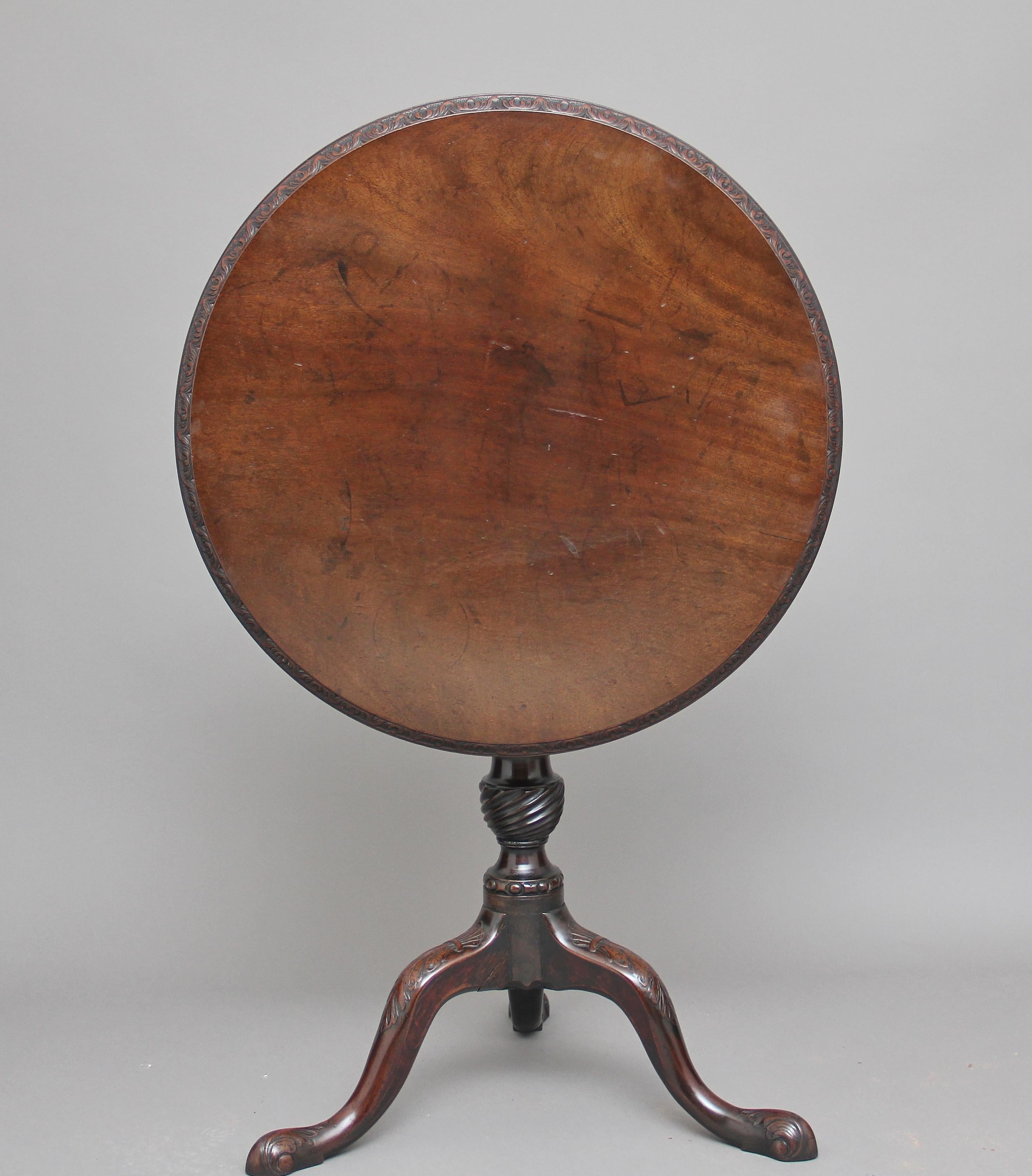 A lovely quality 18th century carved mahogany tripod table, the circular top having an ornate carved edge, sitting on a birdcage mount so you can turn the top without turning the base, supported on wonderfully turned and carved column terminating