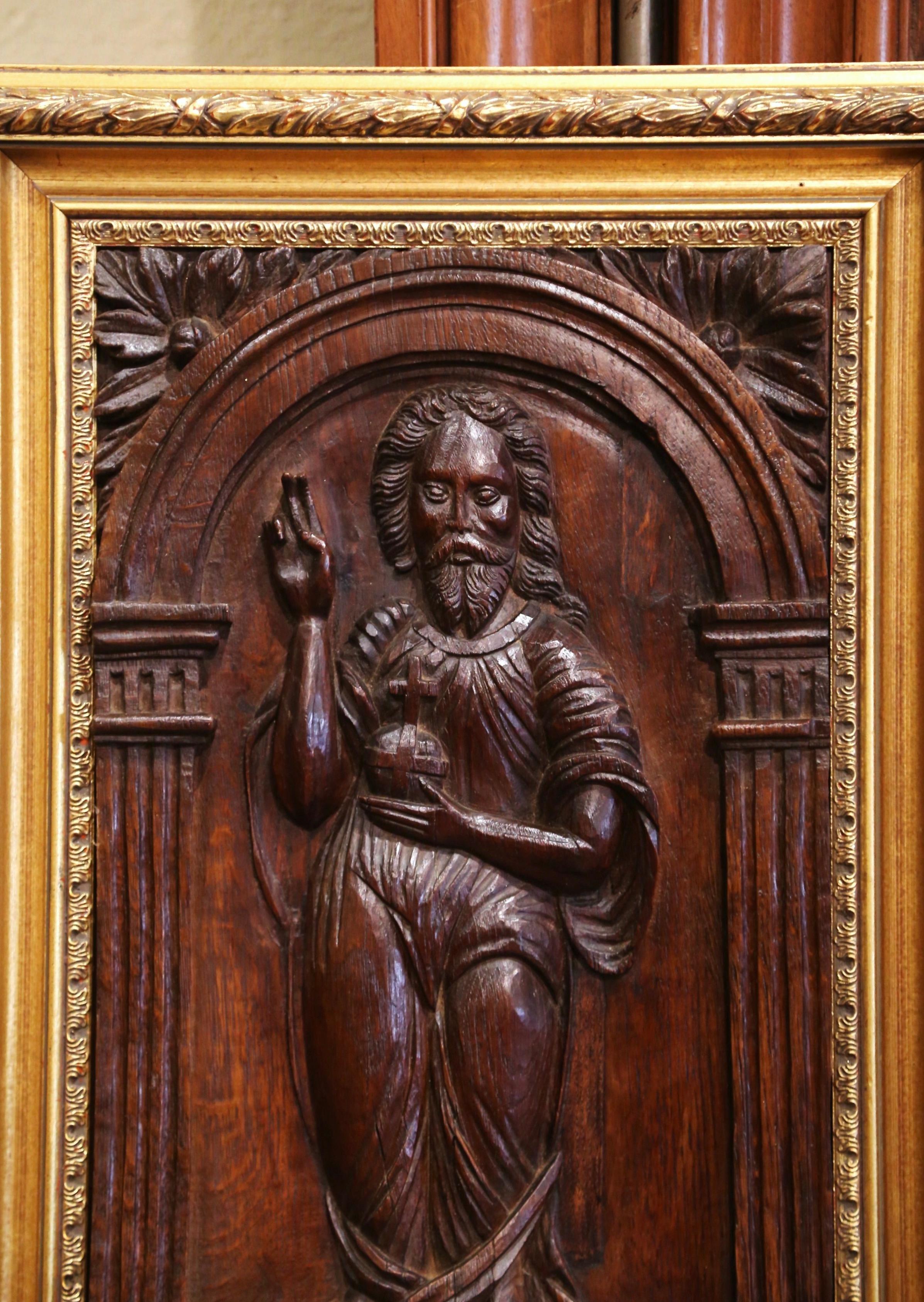 This antique sculpture was crafted in France, circa 1780. Set in a giltwood frame and carved of oakwood, the panel depicts our Lord Jesus Christ standing inside an arched door with the right raised in blessing, in reference to 