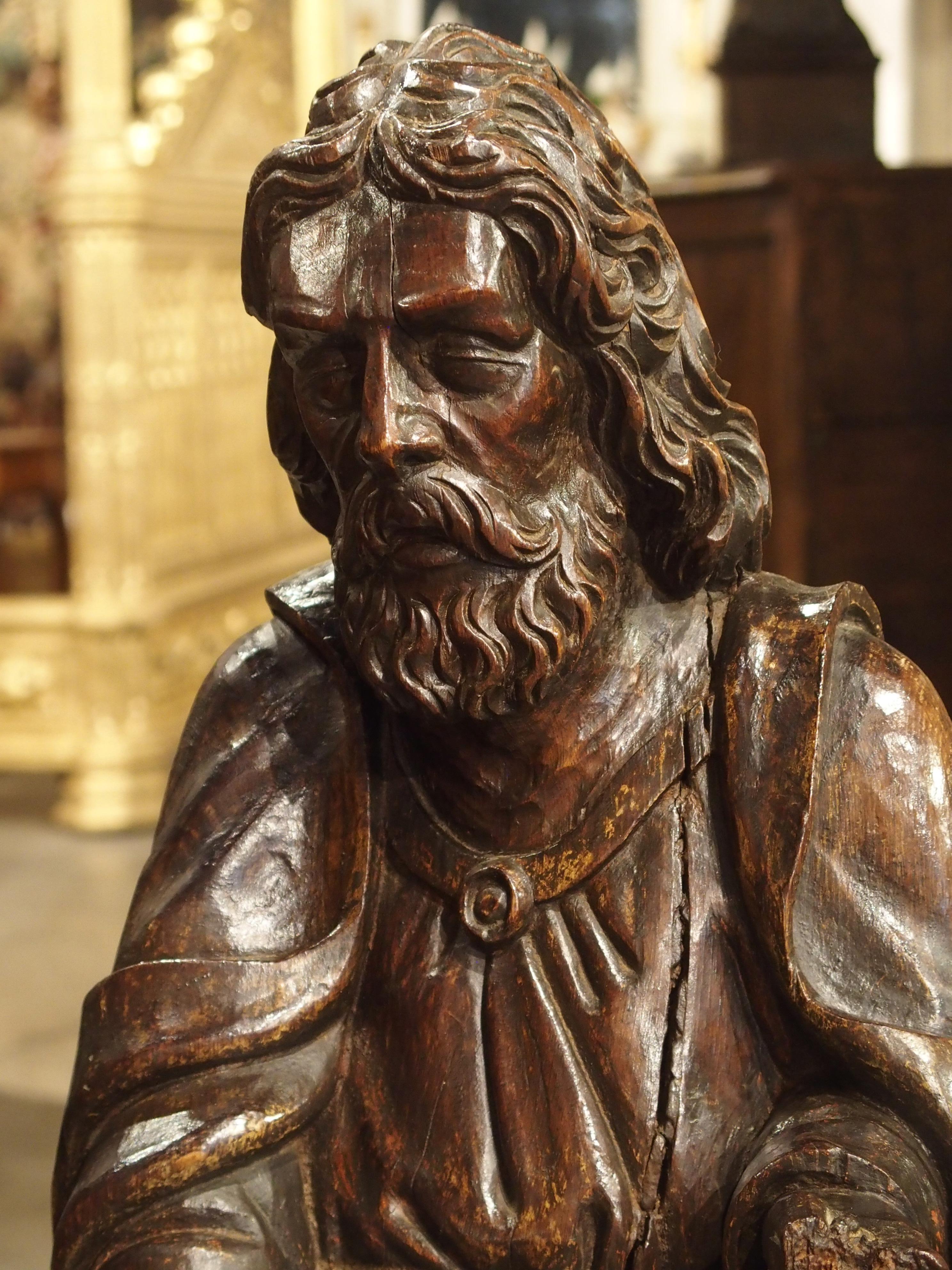 This tall French statue of St. Bartholomew was hand-carved from oak in the 1700’s. This depiction of St. Bartholomew is not often seen in art, except for one of the most well known renditions, which is in the Last Judgement by Michelangelo. This