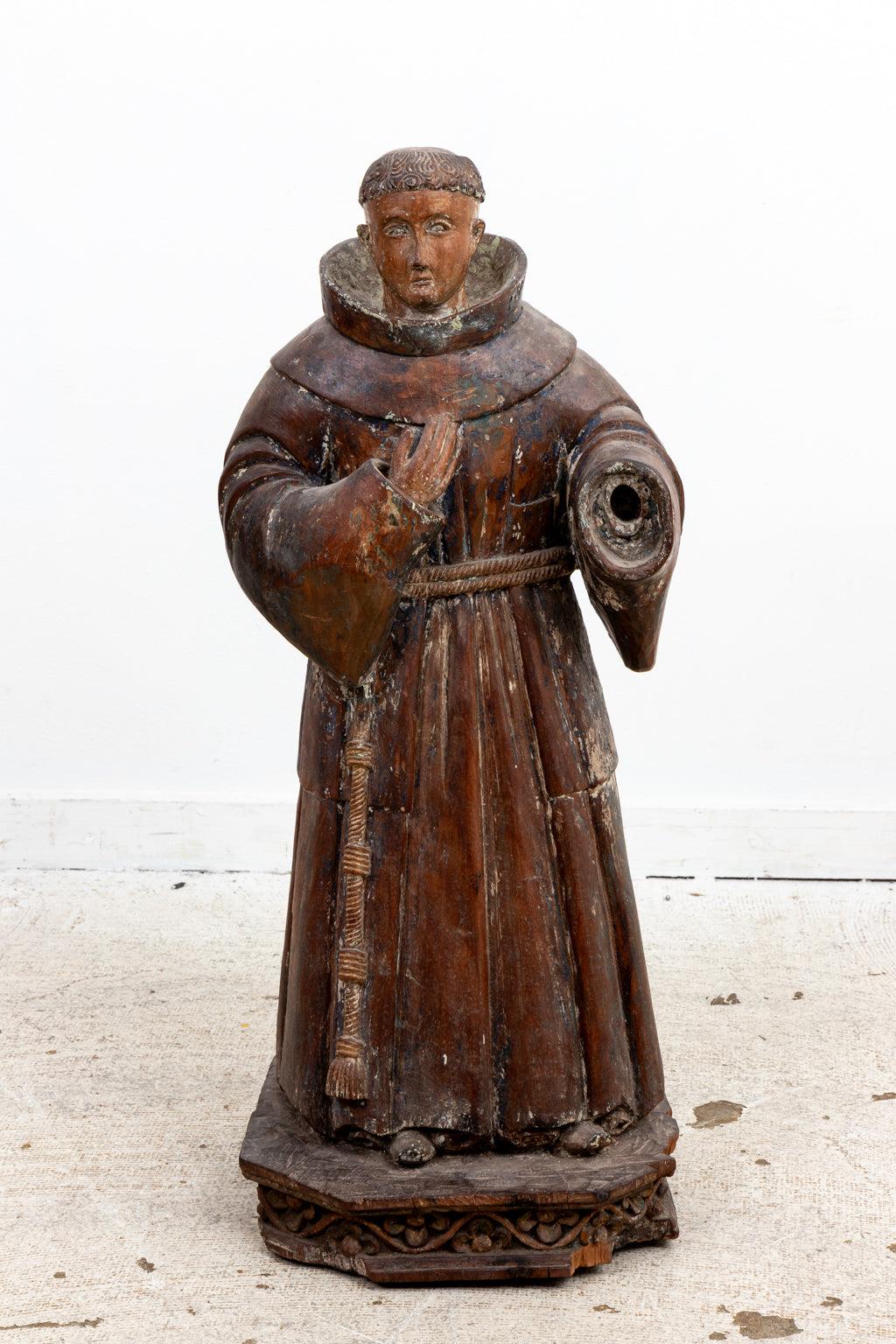 18th Century hand carved Santos, light traces of old color. One hand missing, figure standing on a carved base.
