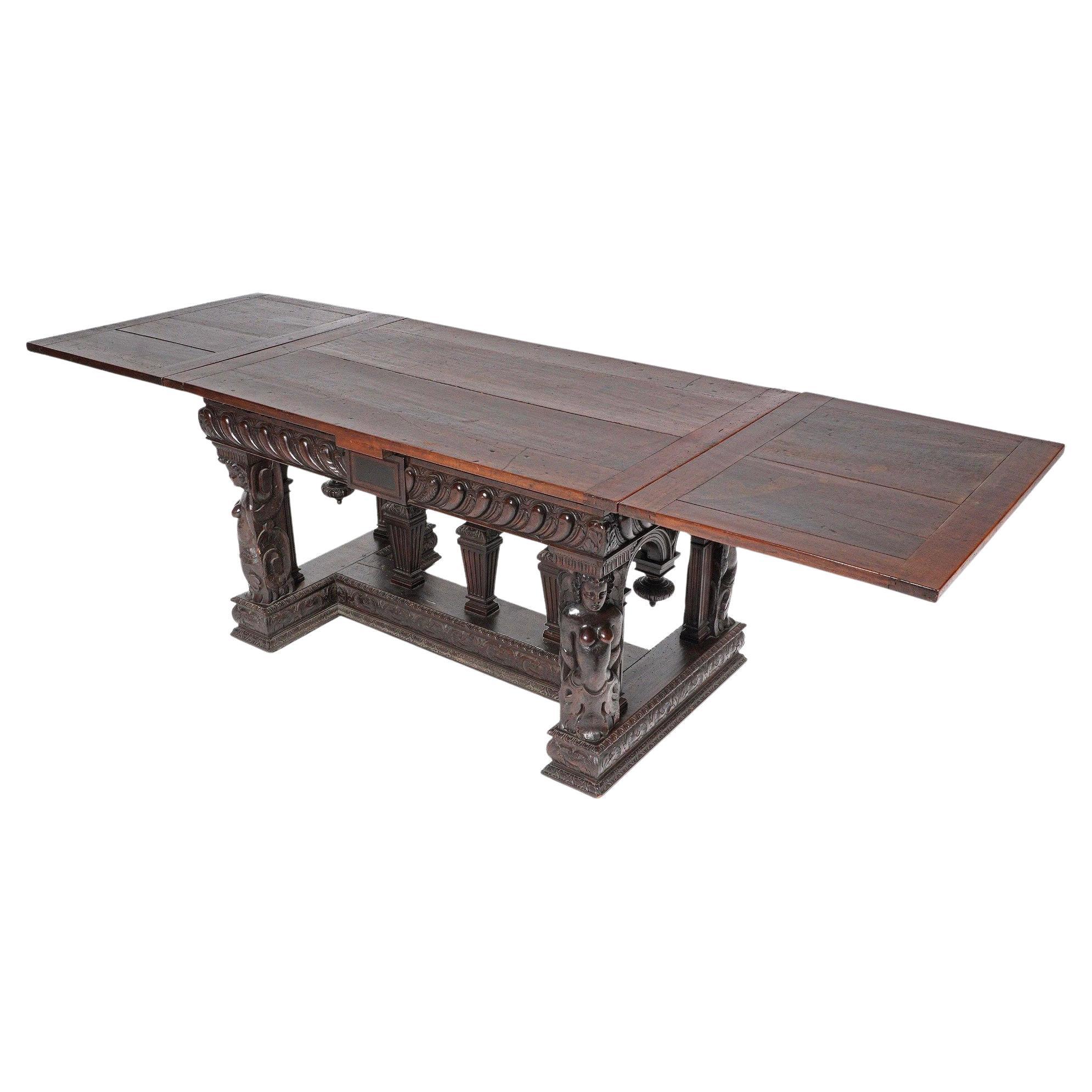 Spectacular 18th Century Carved Walnut Renaissance Style Library Table - dining table. With a rectangular top concealing draw leaves at either end, on richly carved figural maiden carved corner legs, carved and gadrooned skirt and three carved