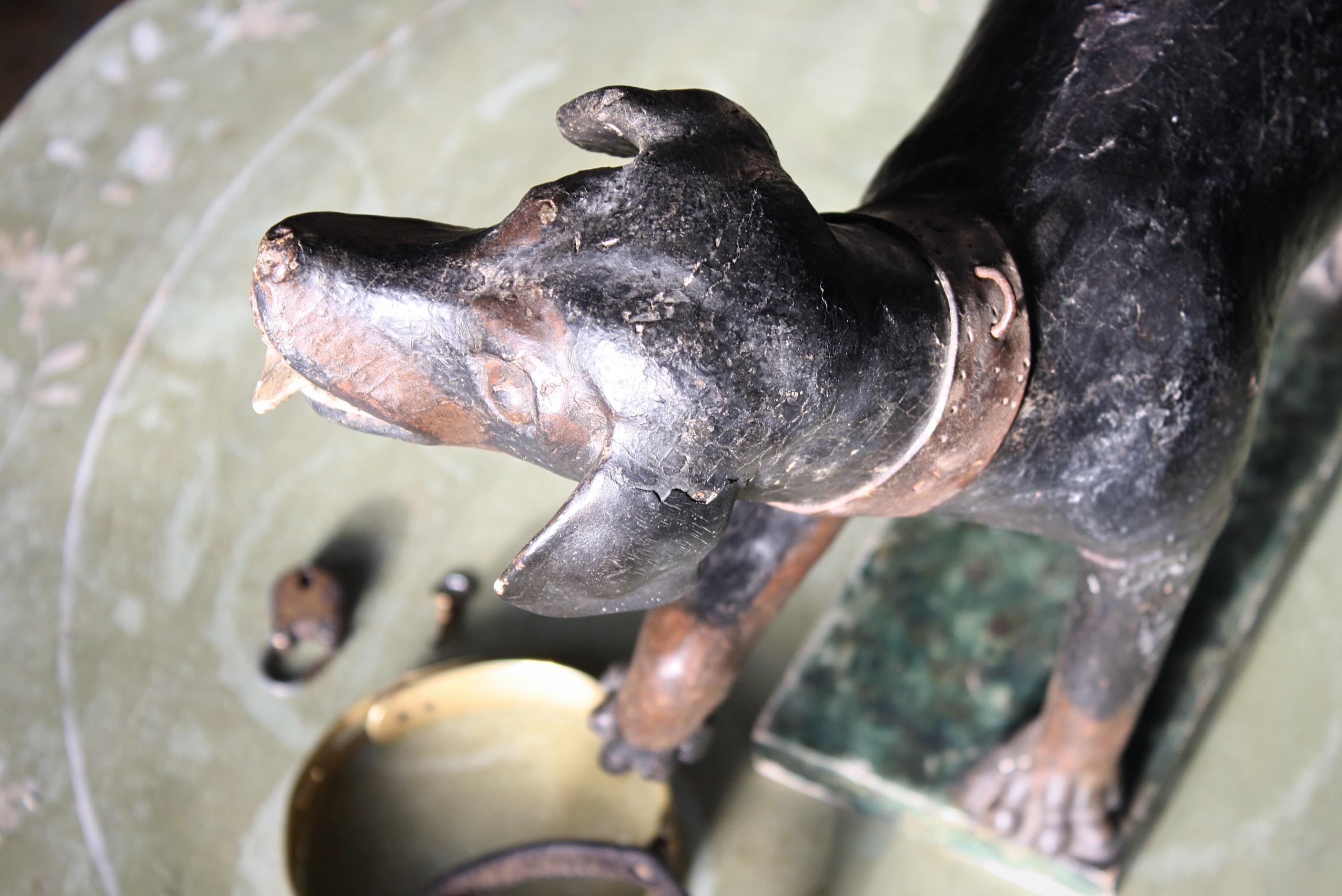 A mid-18th century stylised Talbot, Sleuthhound (bloodhound), carved softwood with its original gesso and painted finish. 

The dog stands on a simple rectangular base with naturlistic ground, and also retains its original leather collar.

The