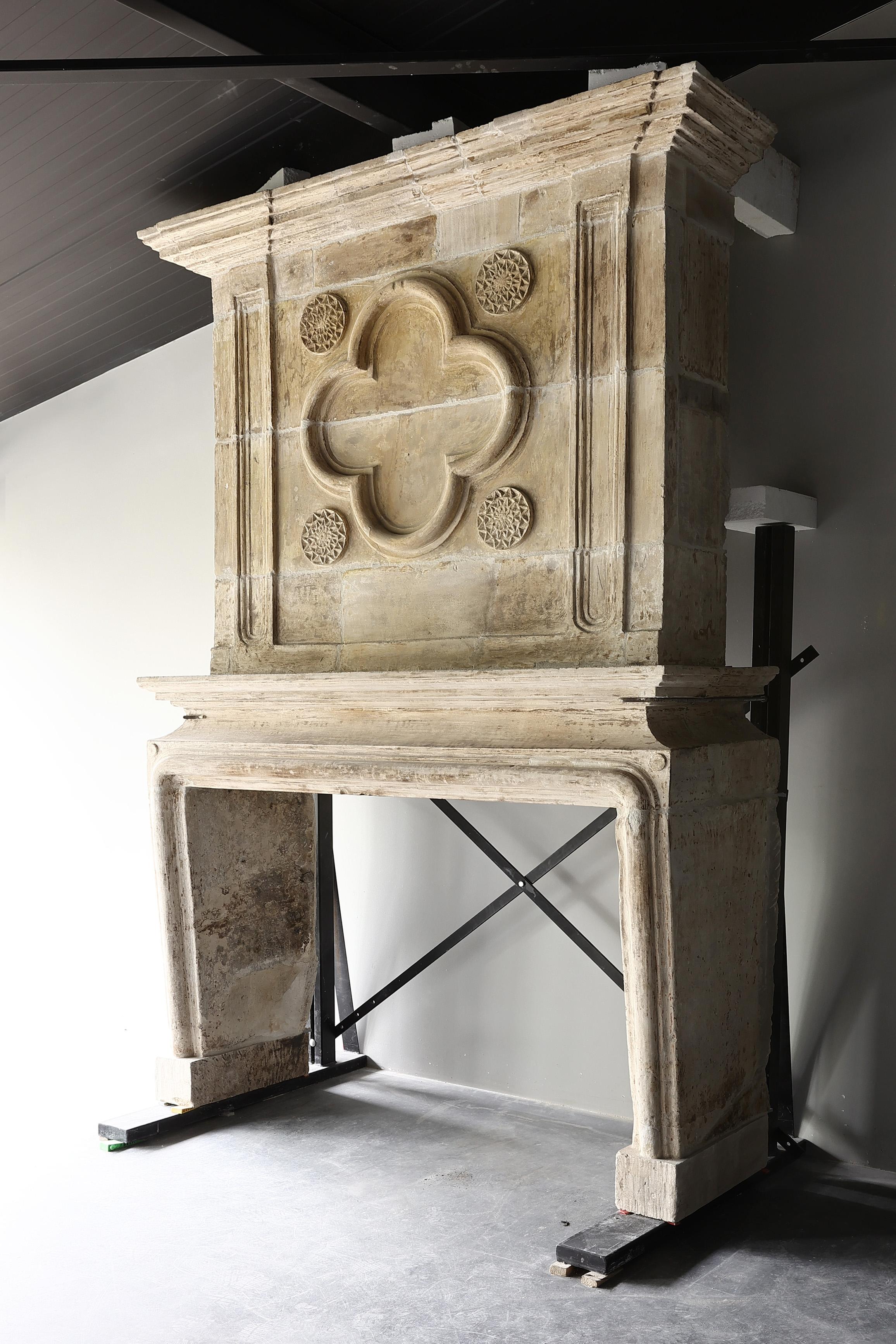 French 18th century castle fireplace of french limestone with trumeau Louis XIV