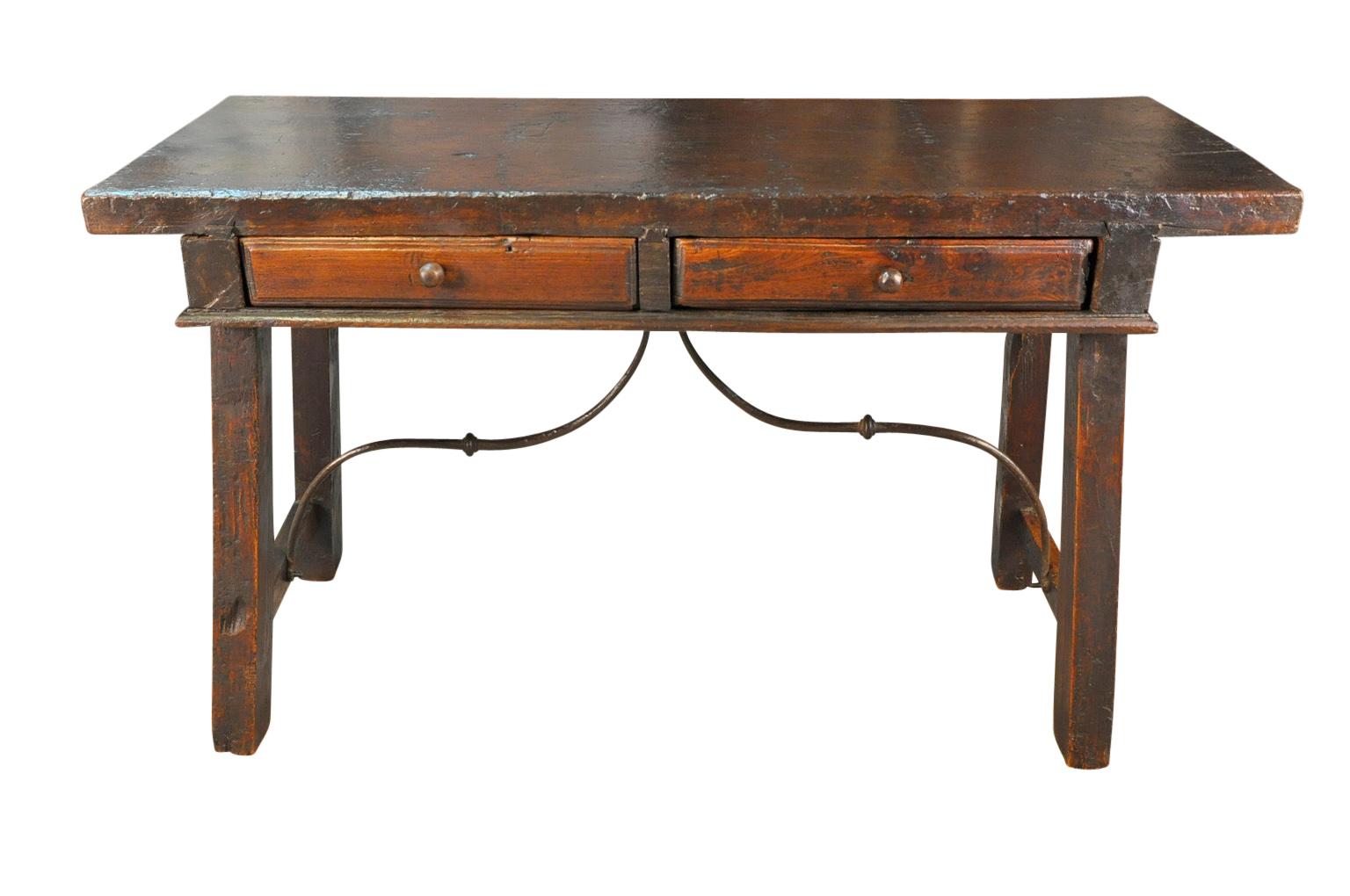 An outstanding 18th century writing table, console from the Catalan region of Spain. Beautifully constructed from wonderful walnut and hand forged iron stretchers - with two drawers and a stunning solid board top. Super patina.