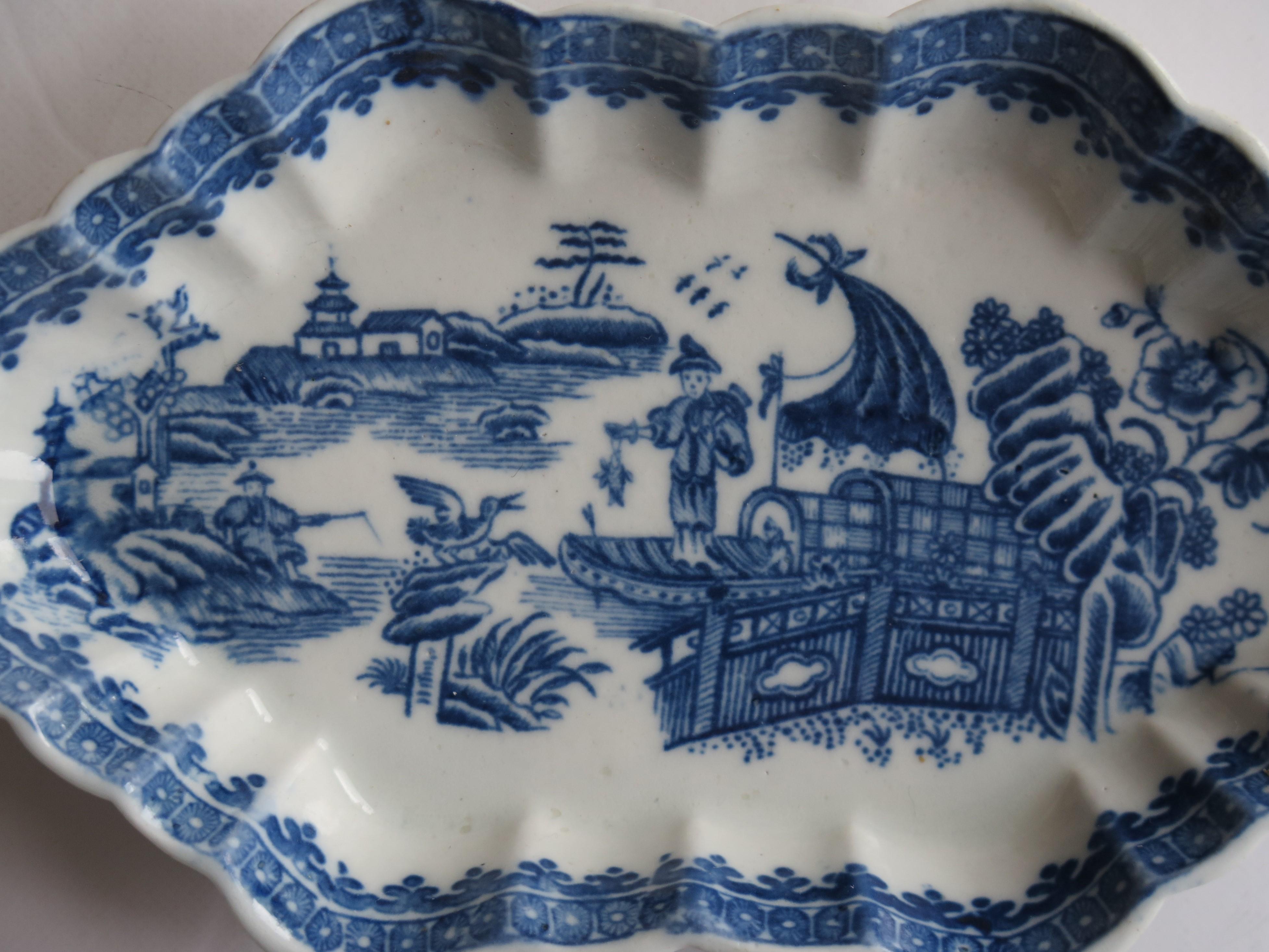 This is an excellent example of a porcelain Spoon Tray made by the Caughley factory, Shropshire, England.

The Spoon Tray is made of porcelain and is vertically fluted with a wavy rim.

It is decorated in the distinctive transfer printed cobalt
