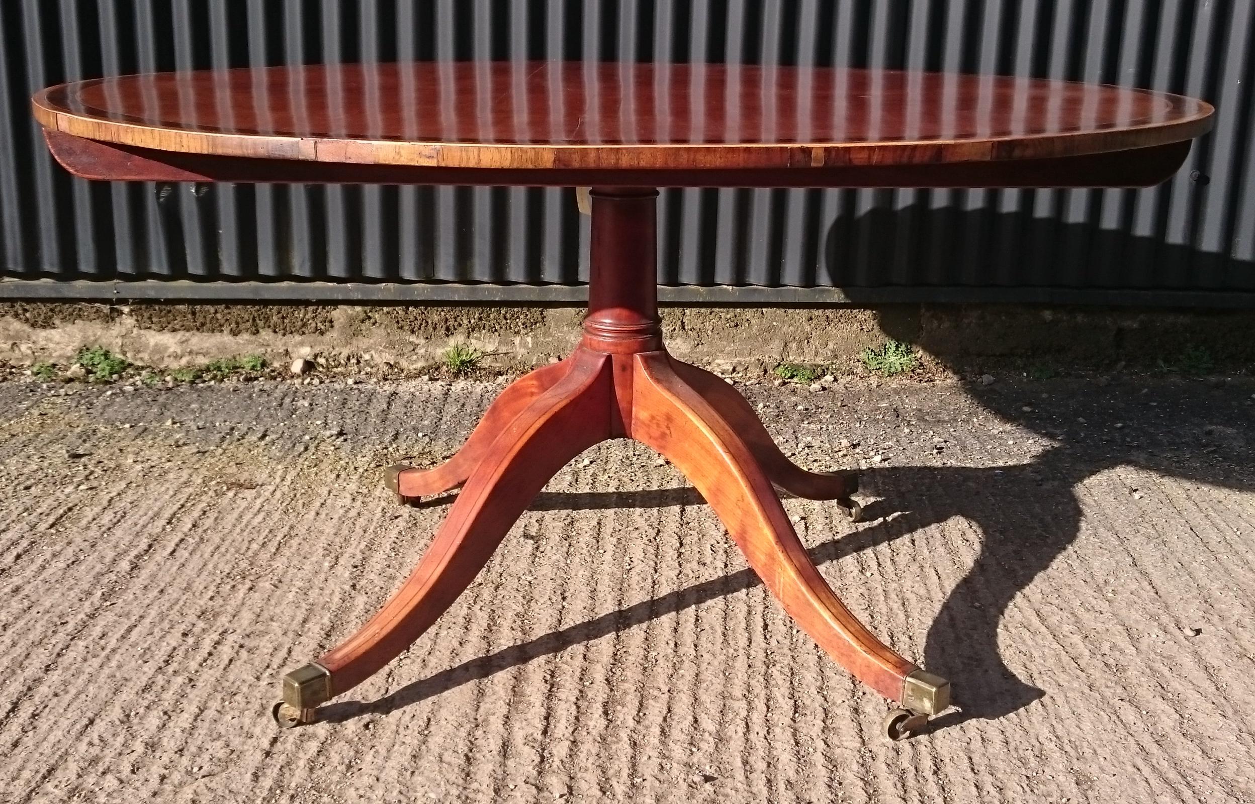 18th century George III period breakfast table or centre table standing on four splay pedestal base. This table is unusual as it is made of satinwood which is an extremely rare and very beautiful timber with a three dimensional quality when viewed