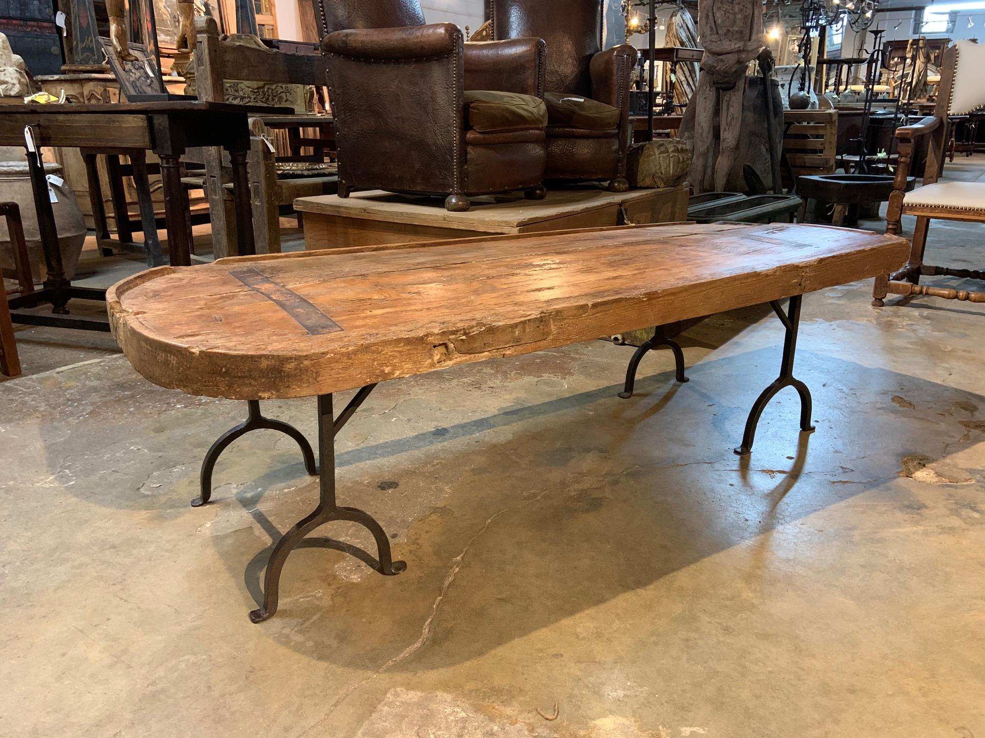 A very attractive 18th century Primitive cheese making board - now as a coffee table... Soundly constructed from an 18th century French cheese making board in pine and an 18th century Italian hand forged iron base. A terrific cocktail table - coffee