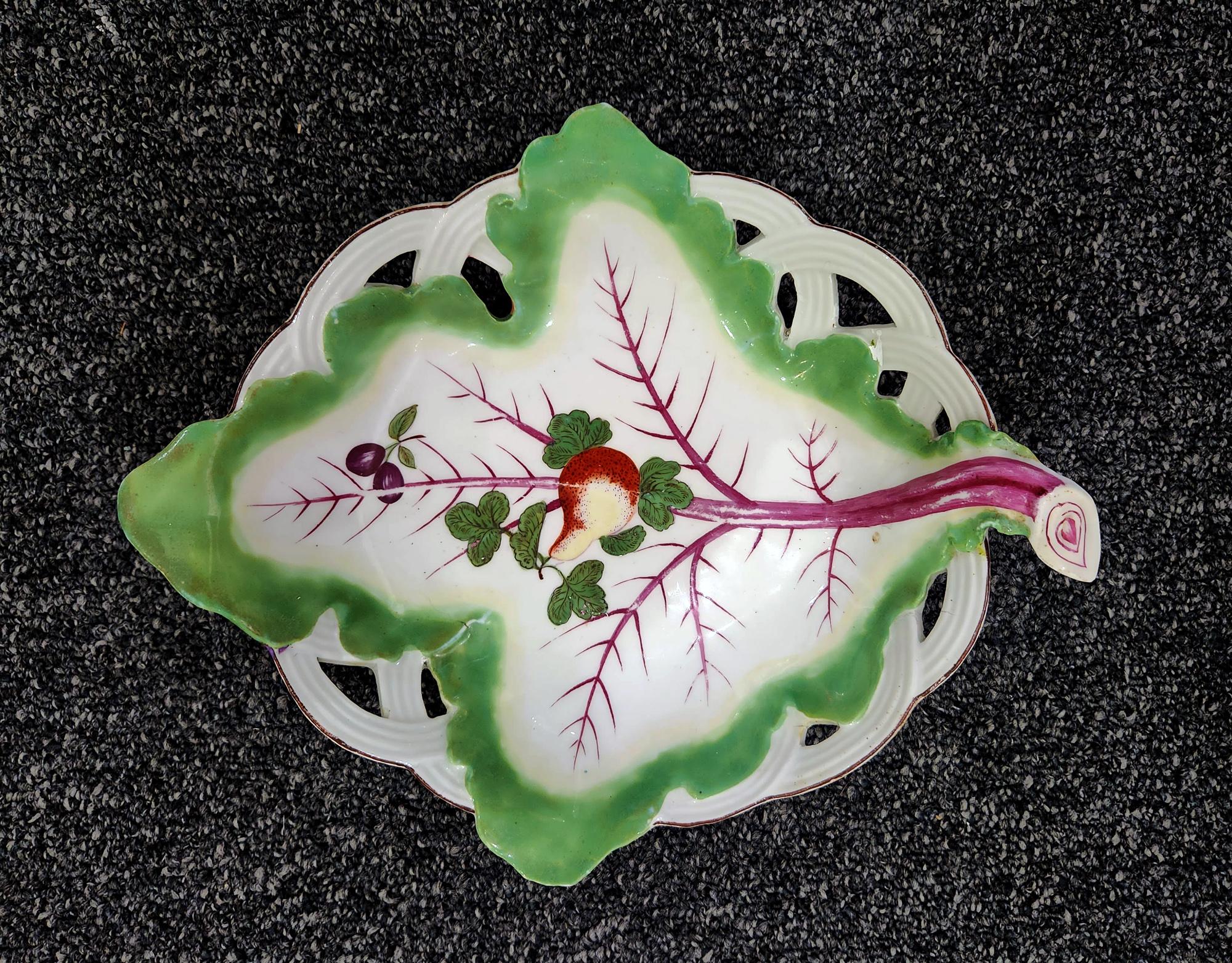 18th century Chelsea Porcelain Trompe L'oeil Leaf Dish with Fruit,
Brown Anchor,
circa 1758-60

The trompe L'oeil porcelain Chelsea Porcelain dish depicts a large green leaf with purple veining draped over an openwork basket. Superimposed on the
