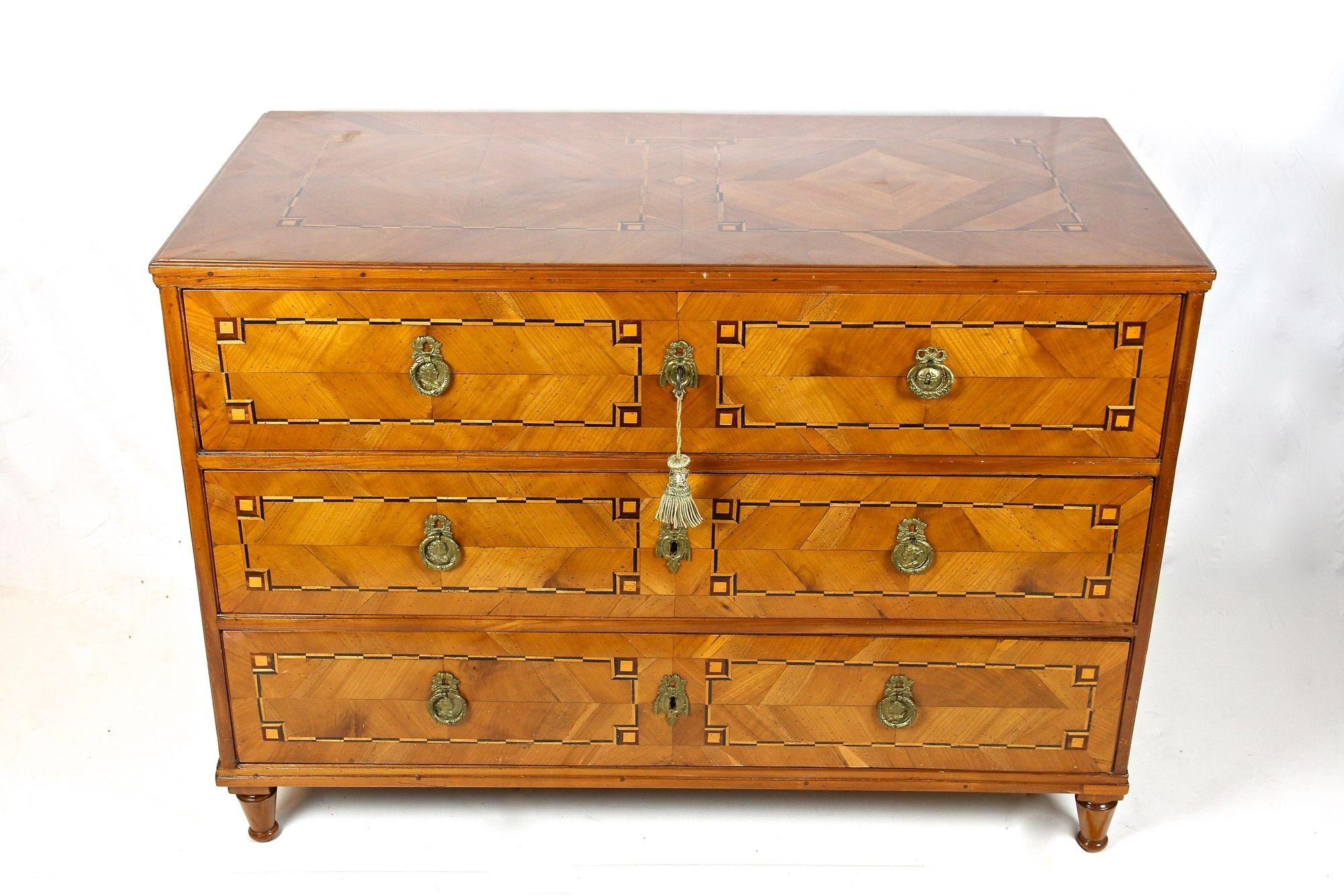 Beautiful cherrywood chest of drawers with inlay works from the late 18th century in Austria around 1790. This over 230 year old commode from the so-called 