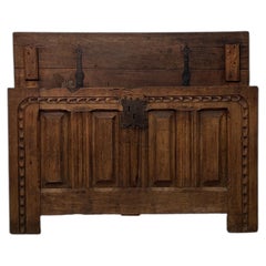 18th-century chestnut chest with finely decorated front and paneled sides.