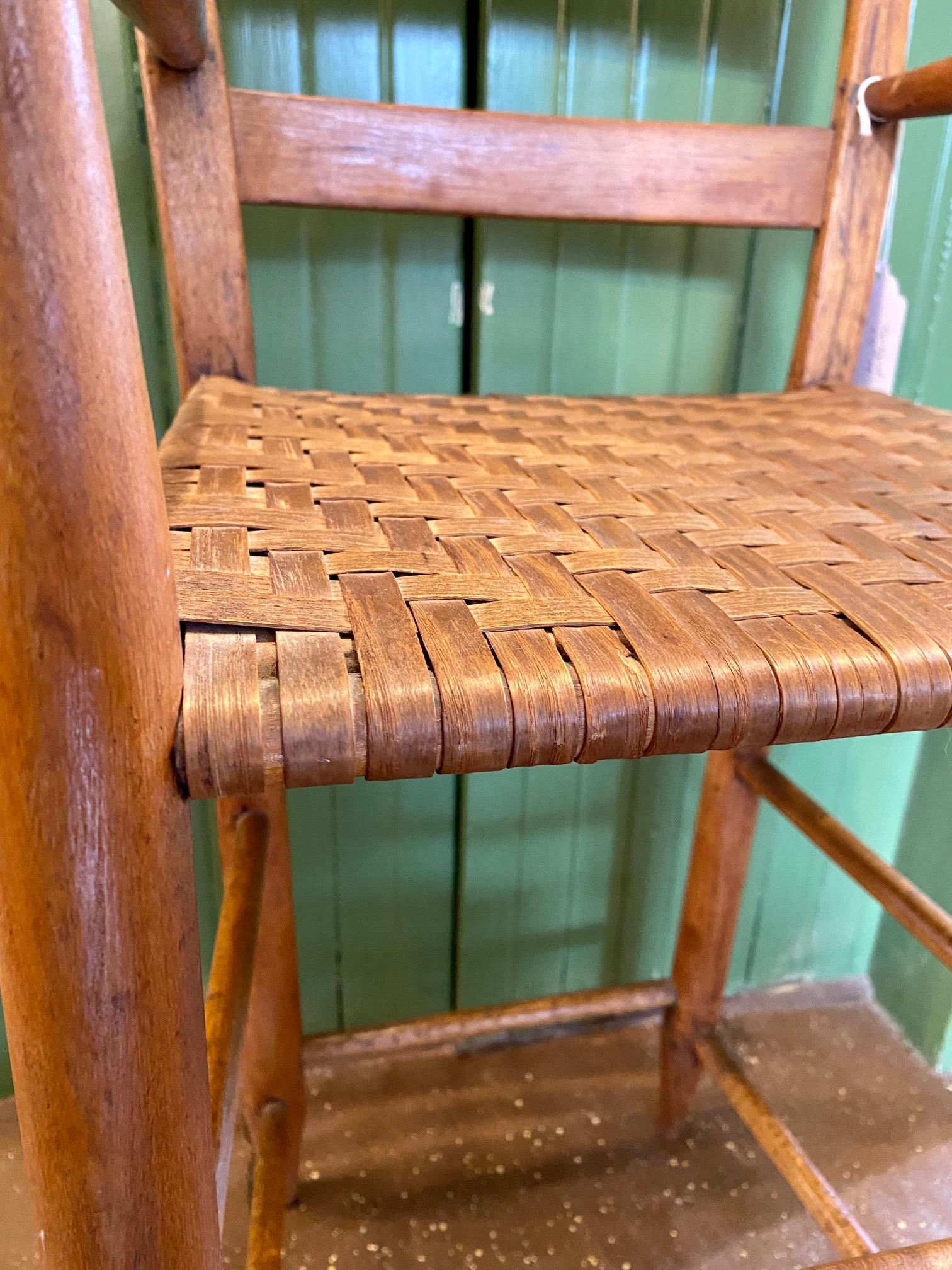 18th Century Child's Thumb Back Windsor High Chair, circa 1780, an American Colonial Period Country Thumback Windsor High Chair with flattened finials on two standards holding two back slats and turned arms above a woven splint seat, raised on