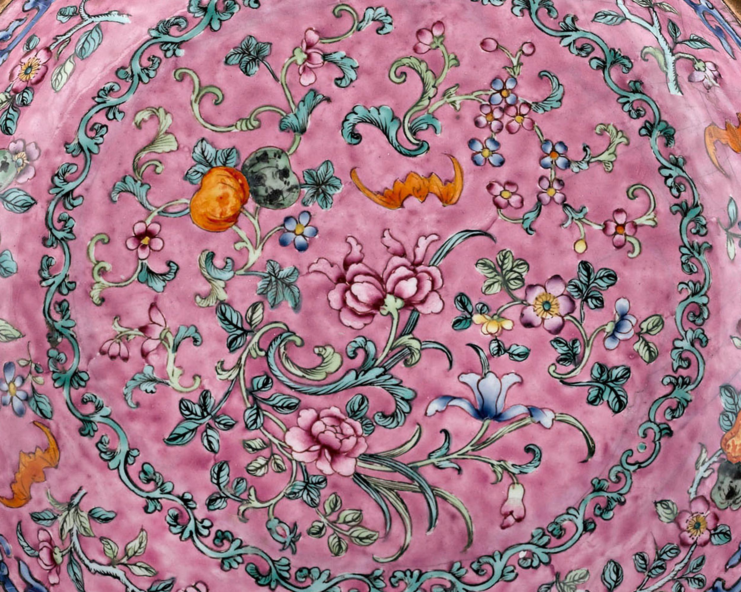 This enchanting Chinese plate, known as Canton enamel, evokes the intrigue and exclusivity of the 18th- century Imperial court. Boasting a magnificent famille rose background hue, this plate is adorned with a sophisticated floral design of