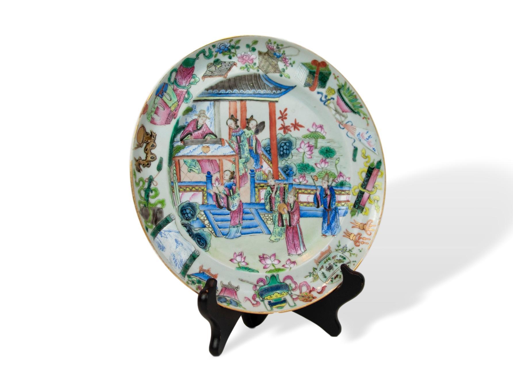 Canton Famille rose 9.6 inch plate, ca. 1840, enameled with seven figures, the four males forming a band, one playing the erhu, one playing symbols, one playing the dizi (bamboo flute), and the seated figure playing the guzheng (plucked zither),