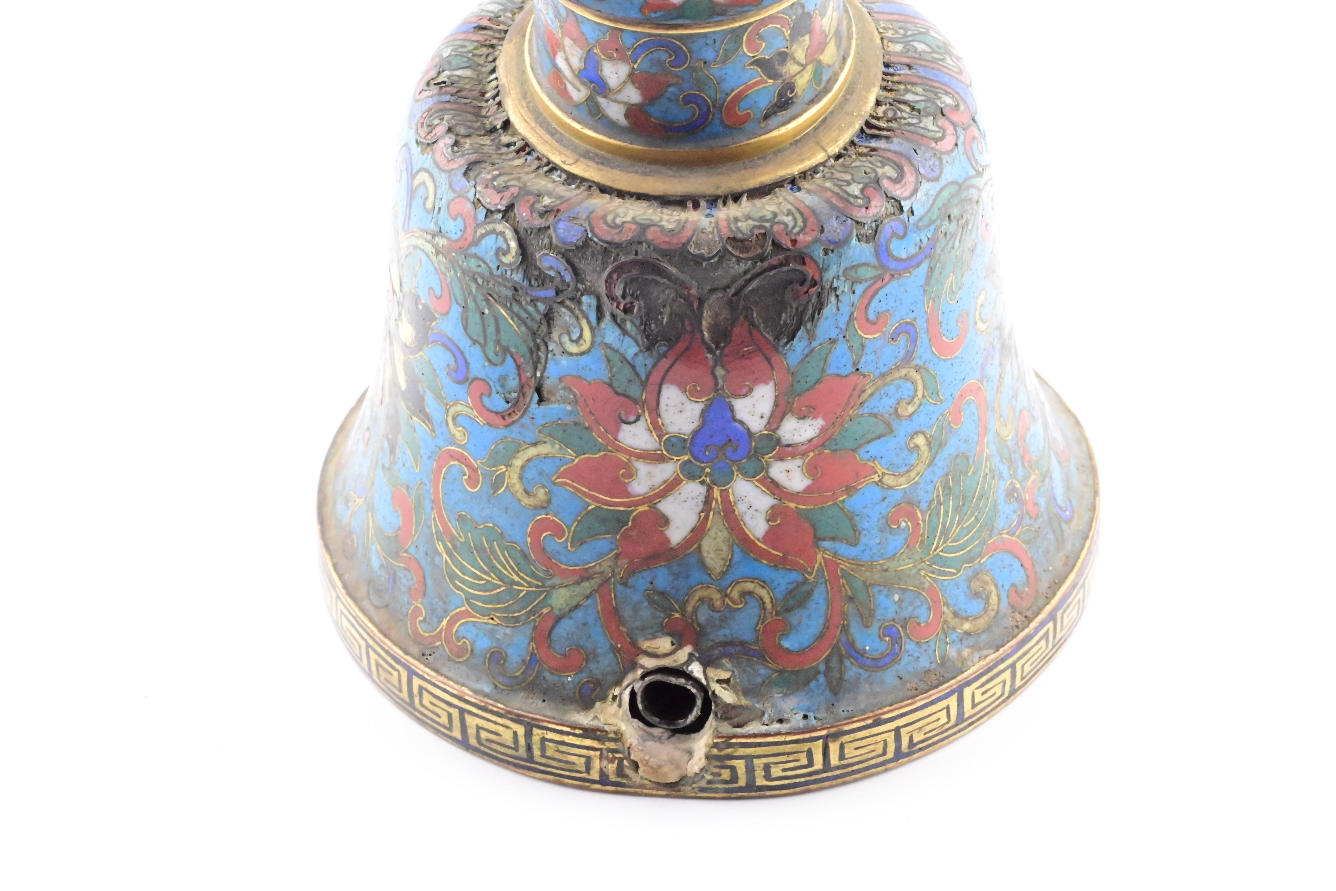 This is an exquisite 18th century Chinese cloisonné bronze candle holder from the Qianlong period. The piece features intricate designs and patterns, showcasing the skillful craftsmanship of the time. It is made of bronze and adorned with colorful
