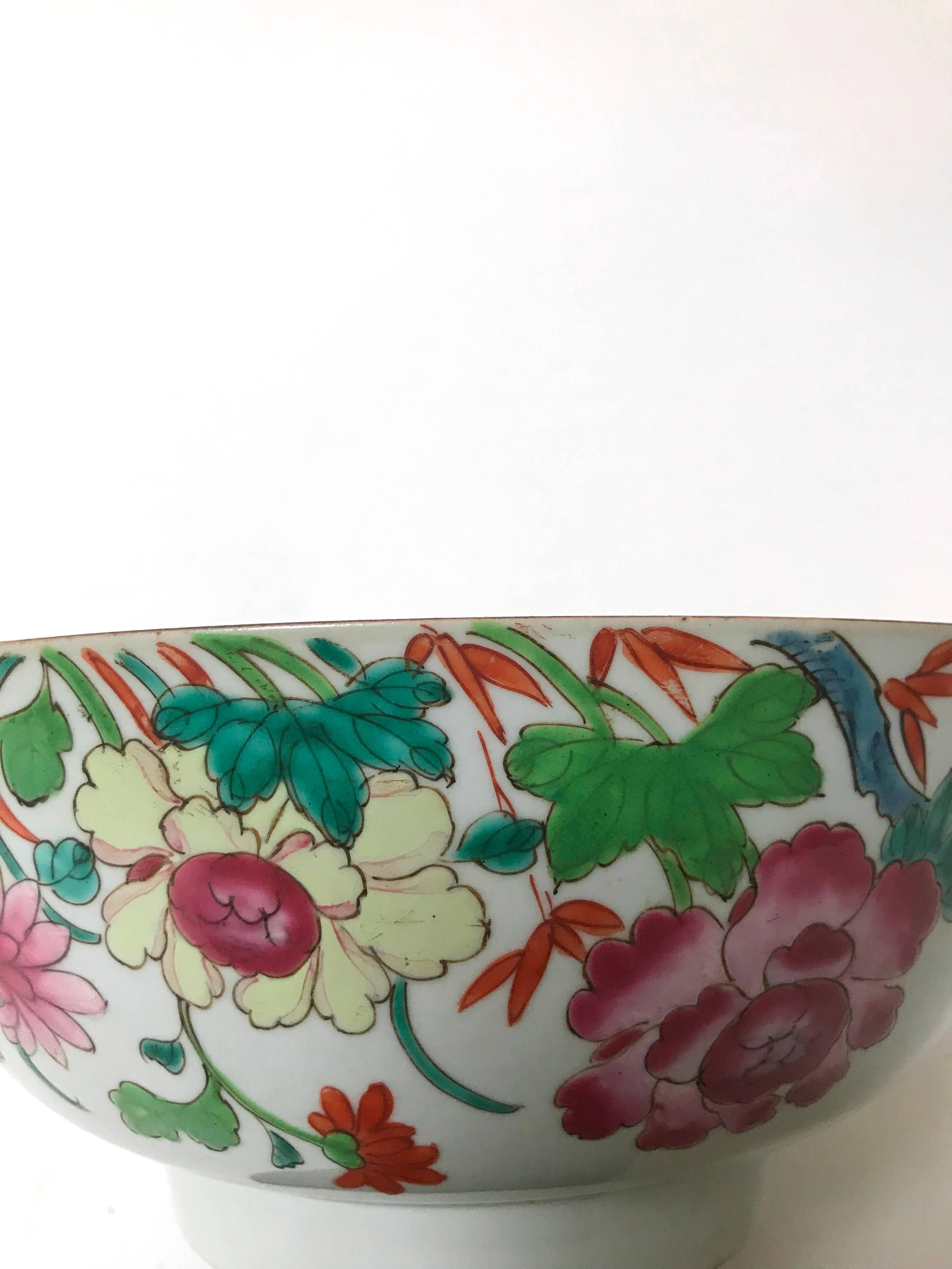 Large Chinese export porcelain centrepiece bowl, second quarter of the 1700s, Yongzheng/early Qianlong period, decorated in famille rose enamels, a floral composition consisting mainly of tree peonies (mudan), the interior rim painted with a frieze