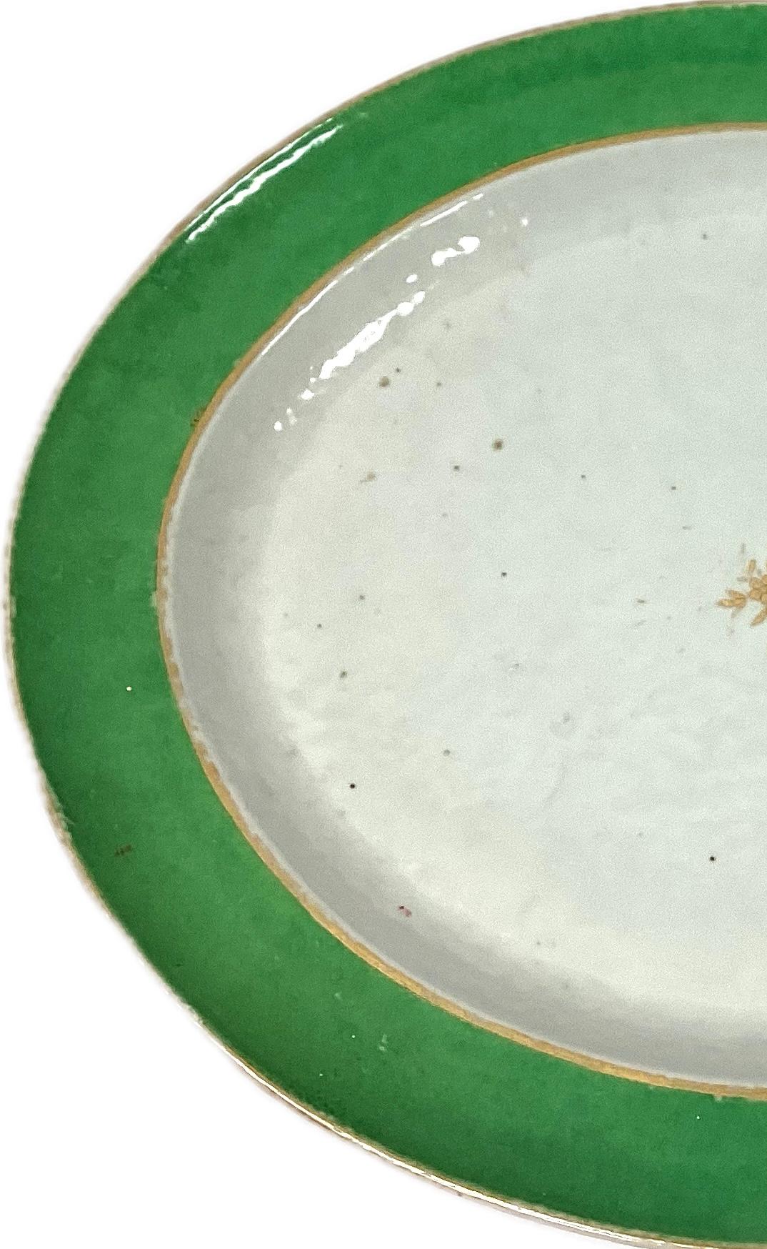 Rare 18th century Chinese Export serving platter. Platter is white with wide green border and gold trim.  Gold accent floral design in center. Platter is very large and would continue to make a great piece of serve ware or could be used as part of
