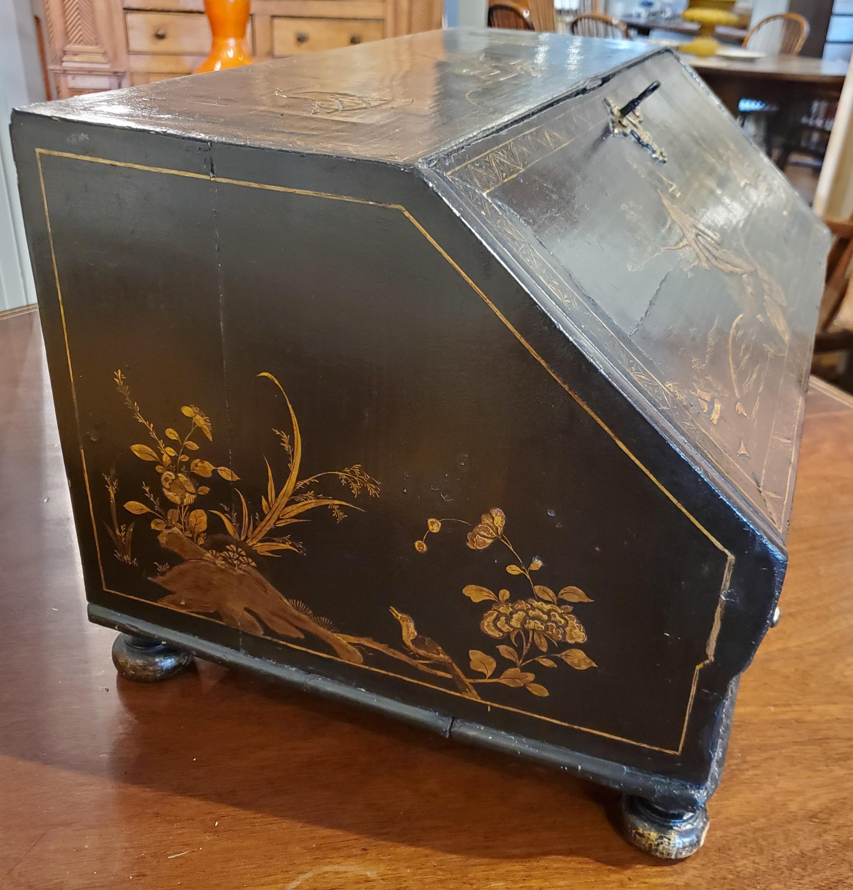 Rare 18th century black lacquer Chinese export writing desk with chinoiserie decoration. Unusual small size, made to be table mounted with fitted interior and retaining original brass hardware. Beautiful decorative edition to any Asian influenced