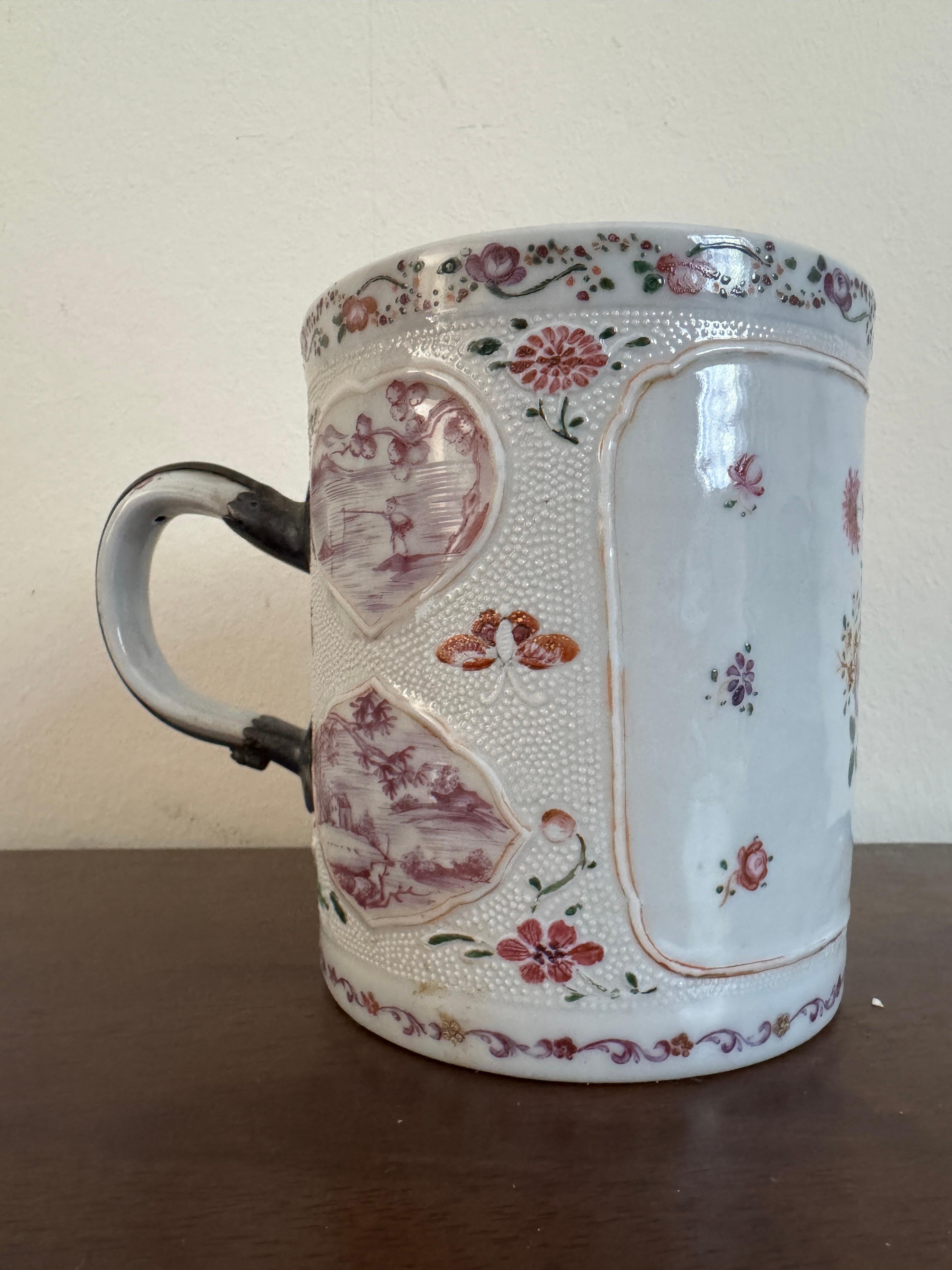 18th Century Chinese Famille Rose Tankard, decorated with flowers and traditional countryside scenes in applied heart shape panels. 