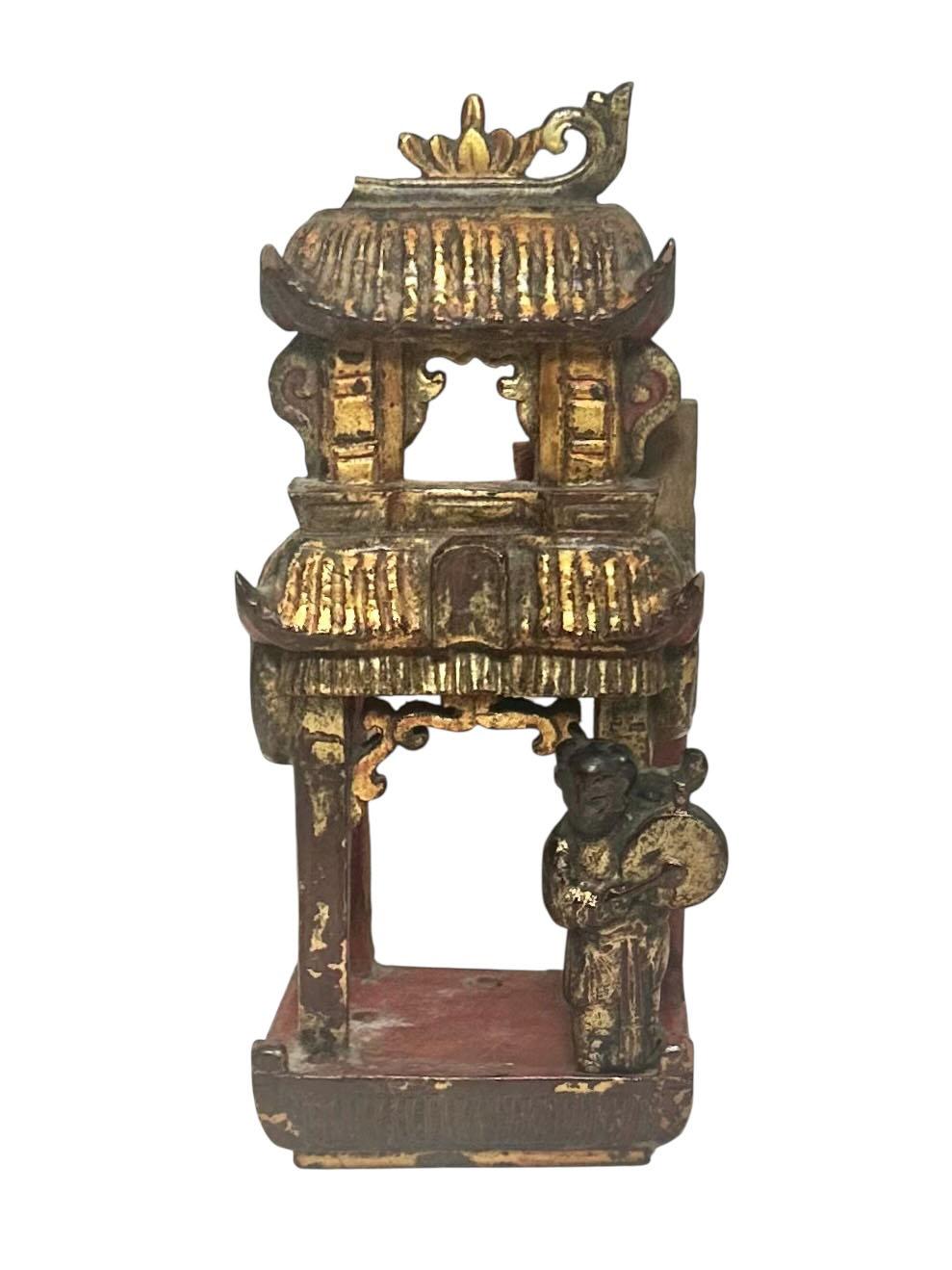An exceptional pair of 18th century Chinese architectural fragments, hand carved from wood and shaped in the likeness of miniature temples or pagodas. These richly detailed pieces feature intricately rendered figures engaged in musical performance,