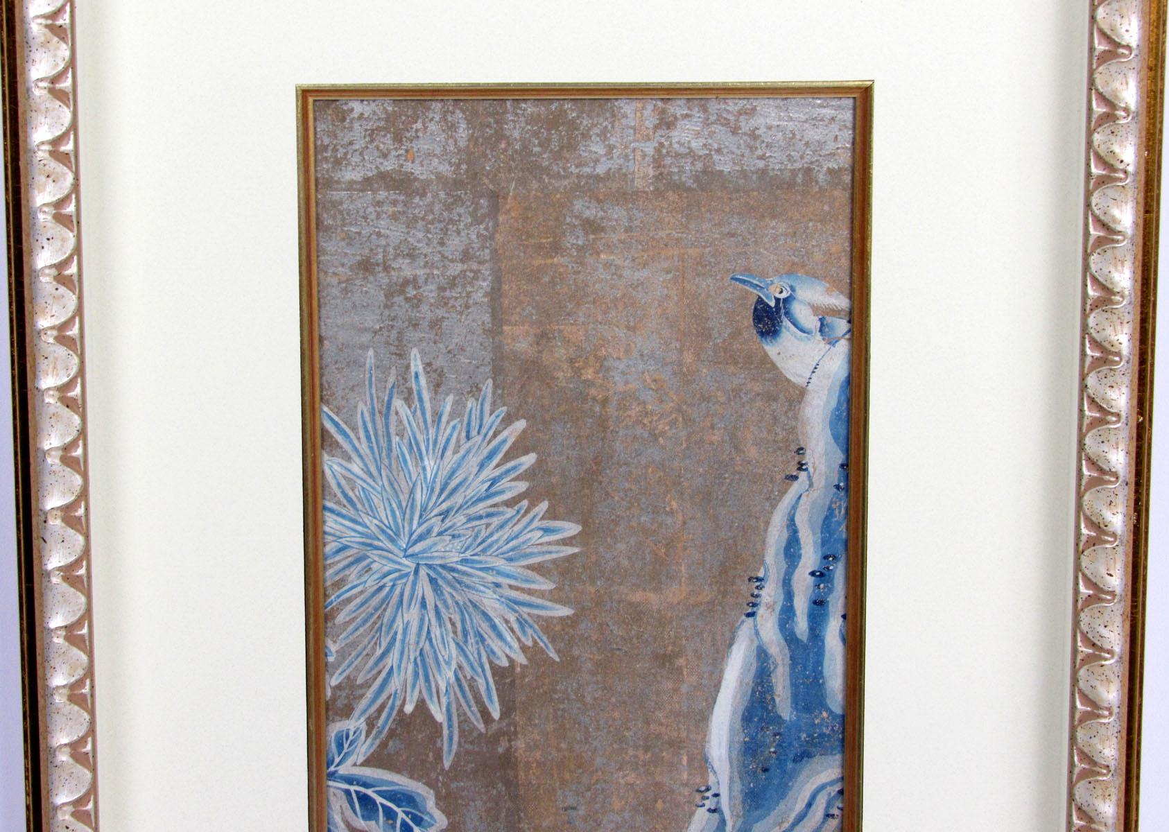18th century Chinese hand-painted wallpaper panel featuring blue and white florals and bird painted onto a gold background, now mounted into a modern frame.