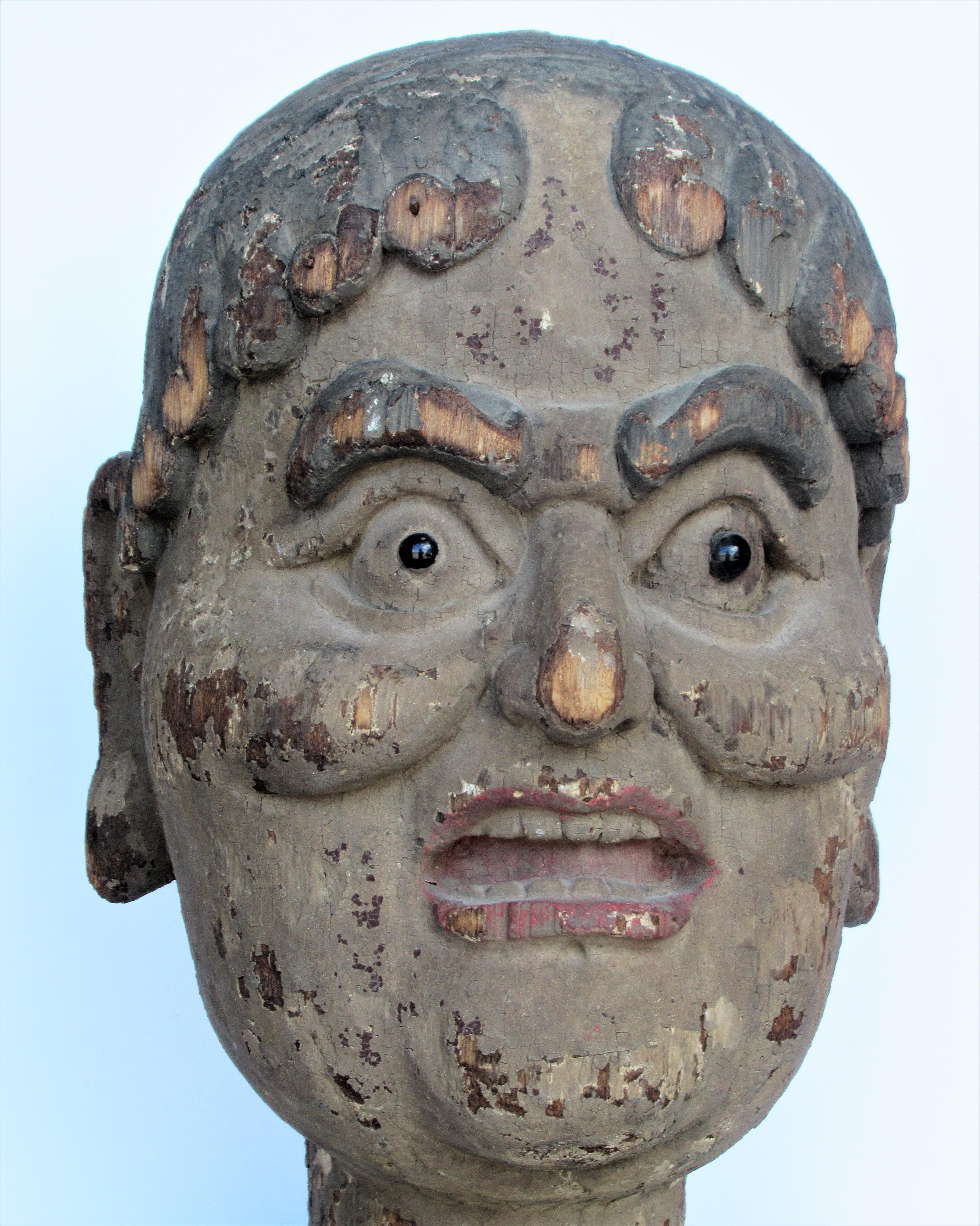 Early antique Chinese life size carved wooden head of  Luohan  ( Lohan, Arhat ) a disciple of Buddha who has reached enlightenment and achieved nirvana. Black glass eyes / beautifully aged worn polychrome painted surface / some remnants of