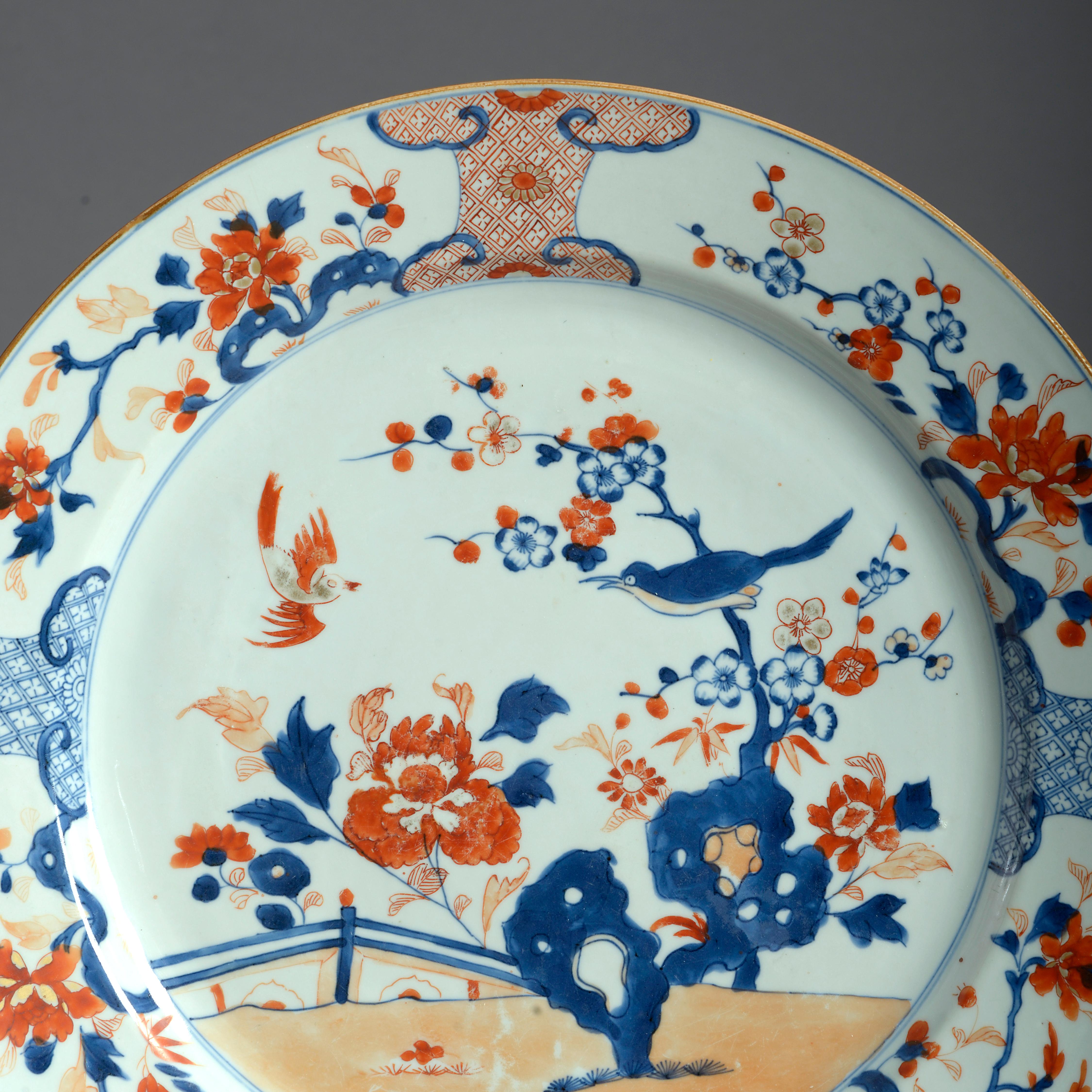 A Chinese Export porcelain charger, decorated in the traditional Imari manner with red, blue and gilded glazes upon a white ground.