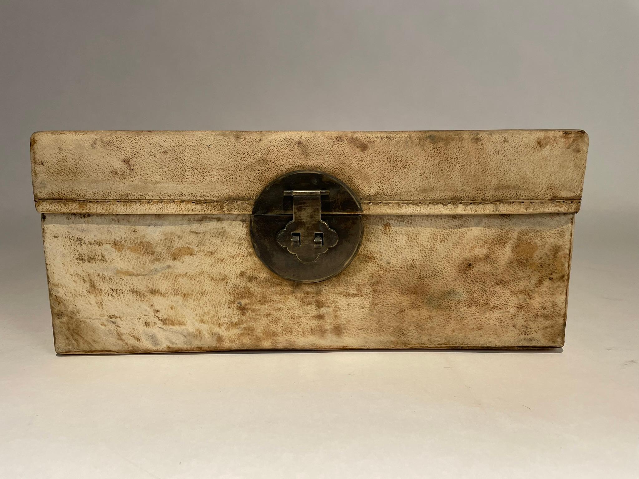 Wonderful and rare 18th century Chinese goatskin parchment covered box with bronze escutcheon and mounts. Love to find a piece like this in original condition. Lined with blue patterned cloth. Classic form, timeless beauty.
16 inches wide 10 deep 7