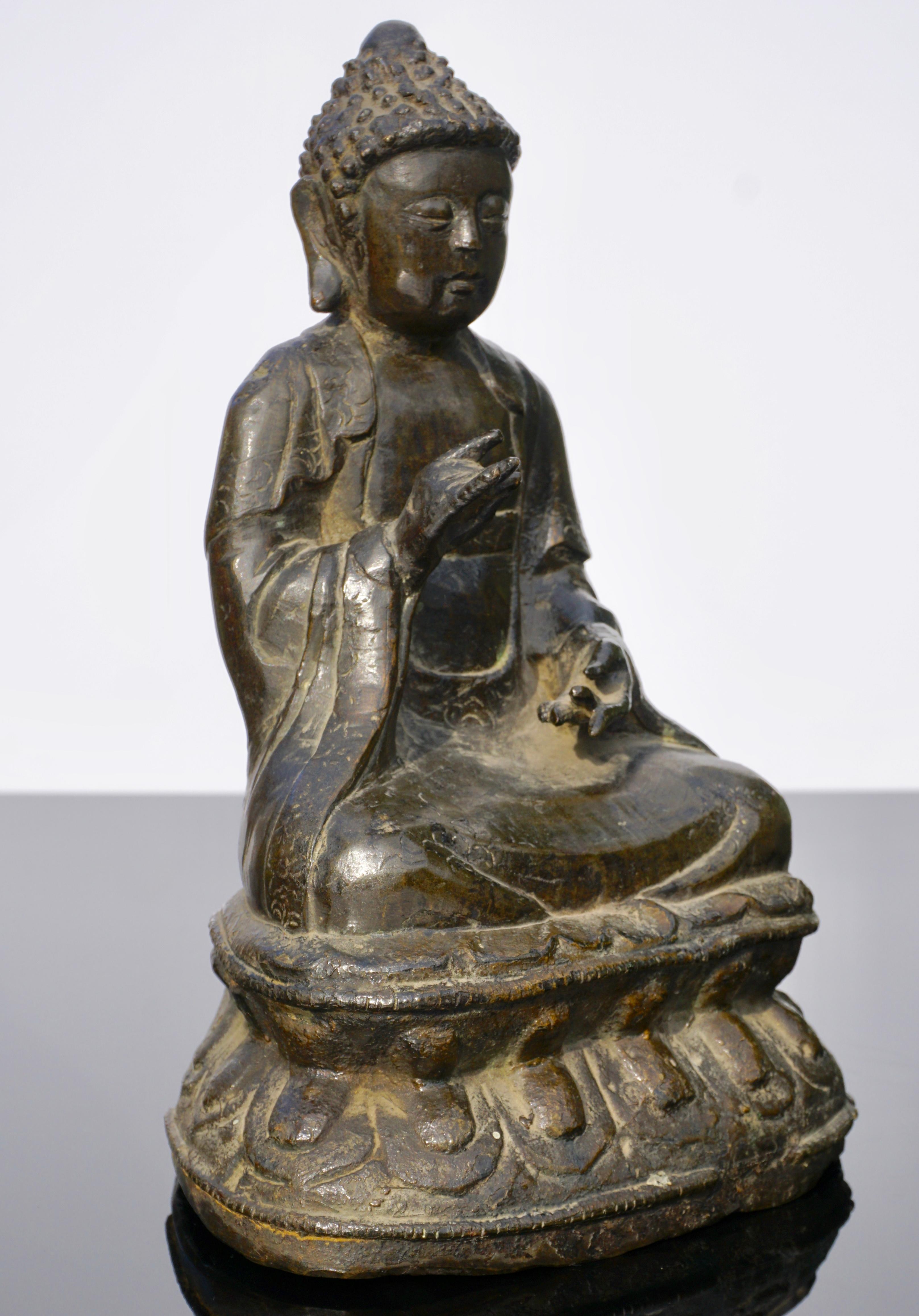 A 18th century or earlier Provincial large bronze figure of Buddha at 10 inches. His gaze downward in serenity his hands in abhisekana mudra seated on a double lotus. A nice older Buddha with limited detail, China, circa 1800.

Measures: Height 10