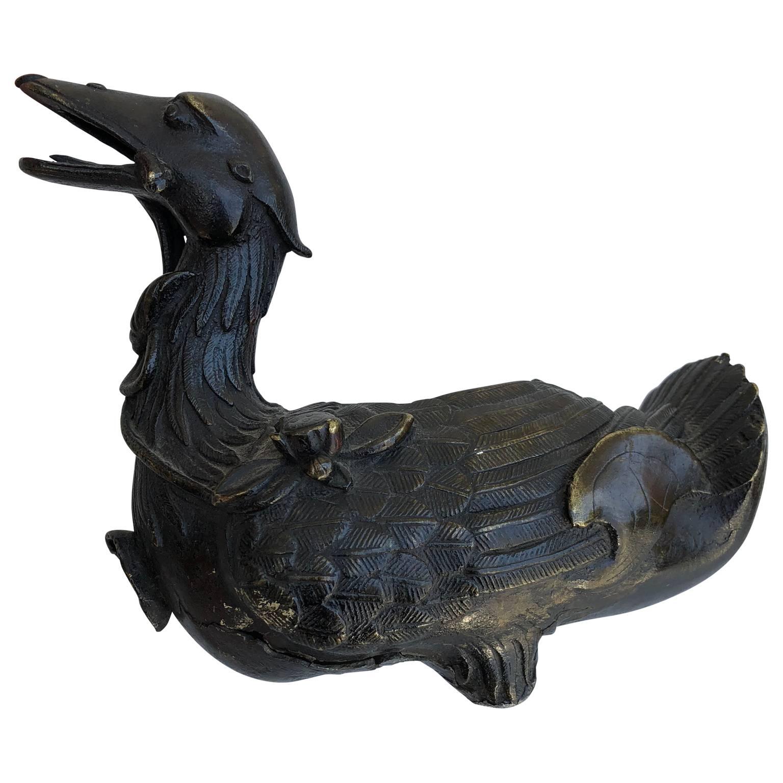 18th century Chinese bronze duck incense burner, Qing period
Please note that one foot is missing, broken off, see detailed image.

 