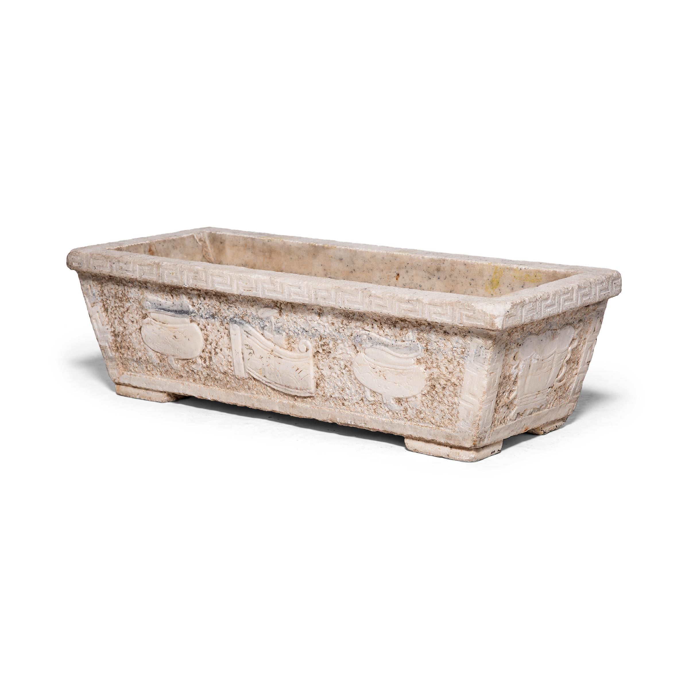 In 18th century China, a trough would have been a fairly common site in rural areas of Shanxi province. However, this marble trough, with its intricately carved decoration and patterned border, is unusually ornate and likely once sat in the