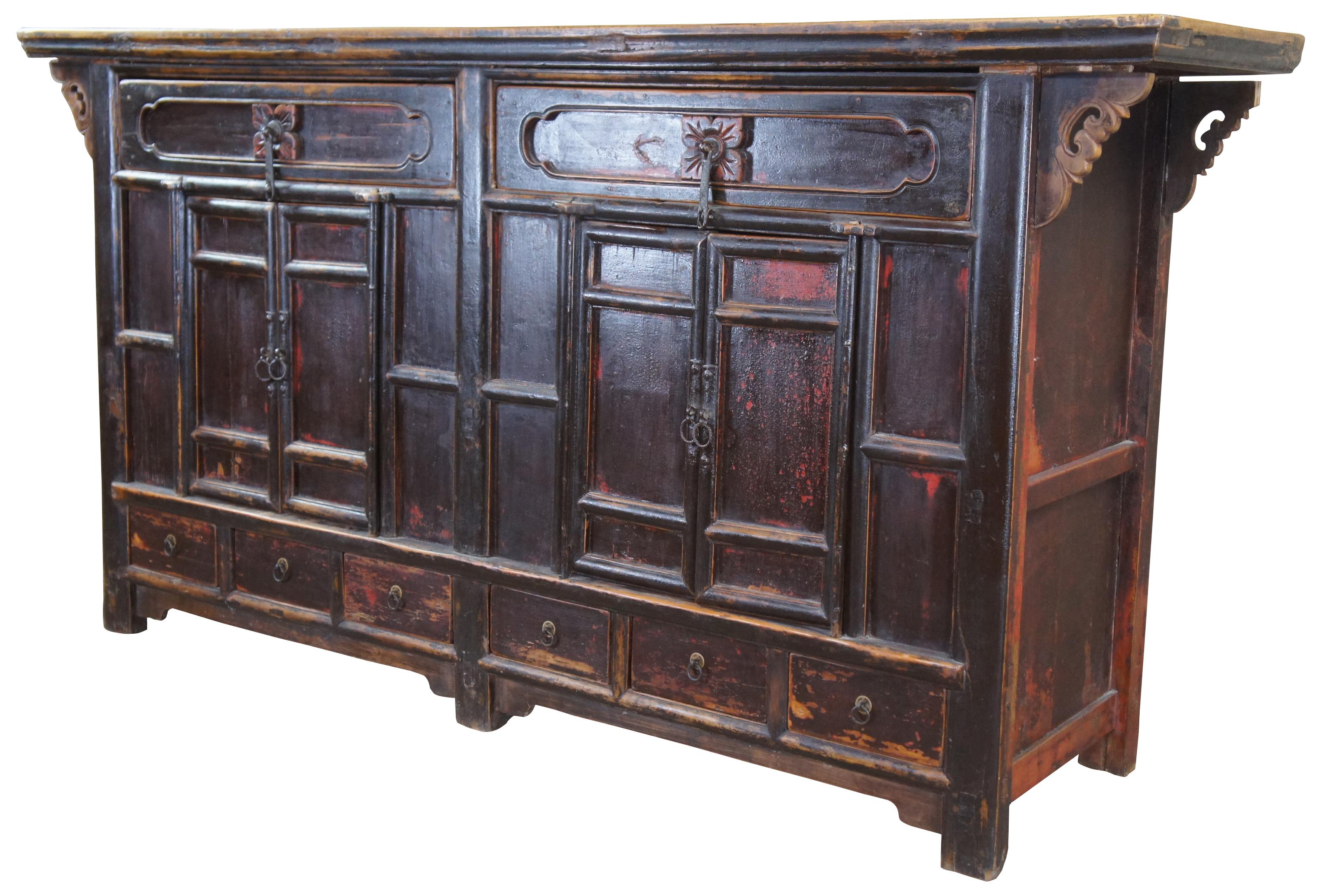 Sporting its original finish, this hand crafted buffet features a floating panel top, with cloud form spandrels, over two long drawers with cloud-form panels and carved florets. Includes two double door cabinets with rounded molding. Adding further