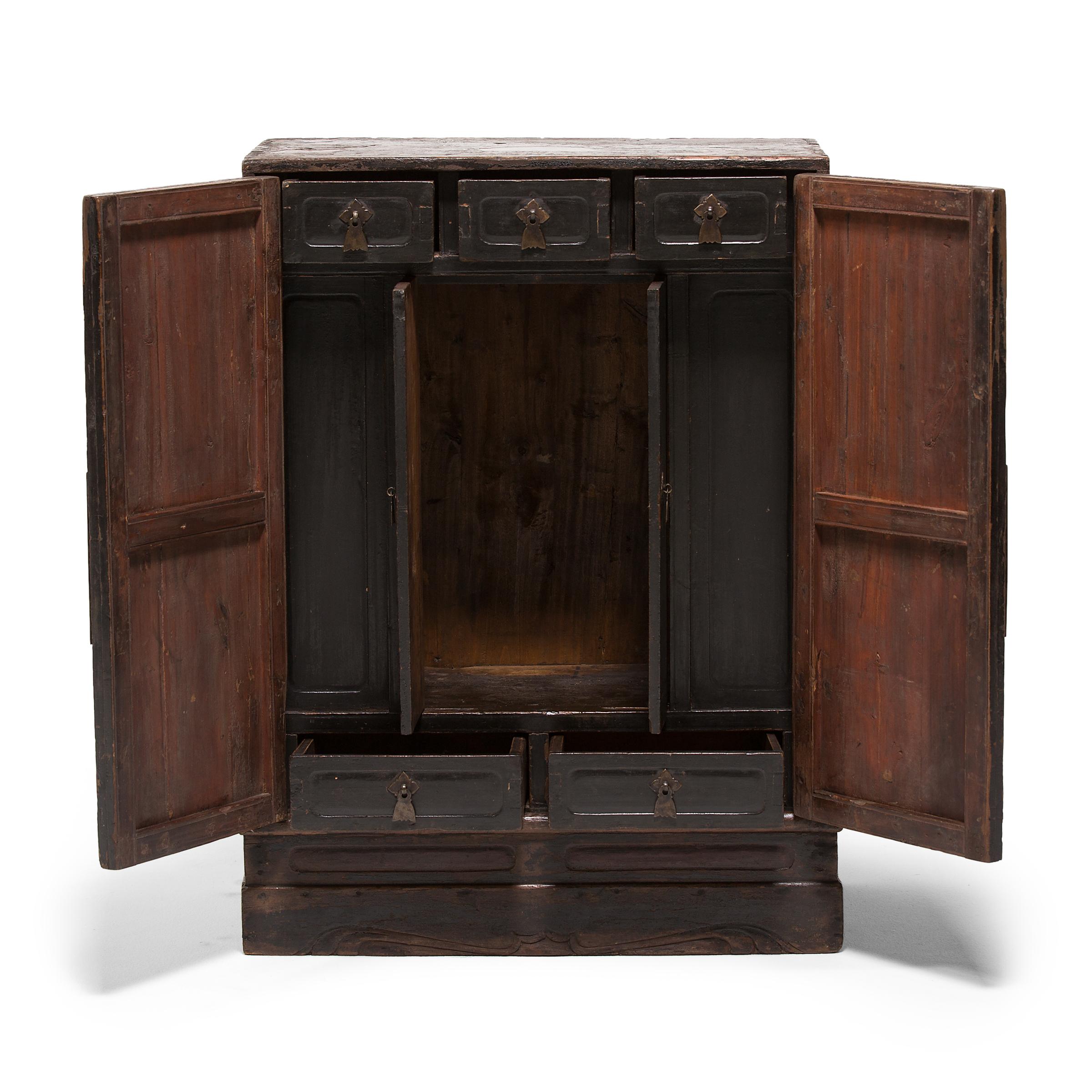 From the outside, this low Chinese cedar cabinet is unassuming. However, opening the two lacquered doors reveals a shrine designed to house altar spirits and incense. It was thoughtfully crafted with drawers and openings to accommodate offerings and