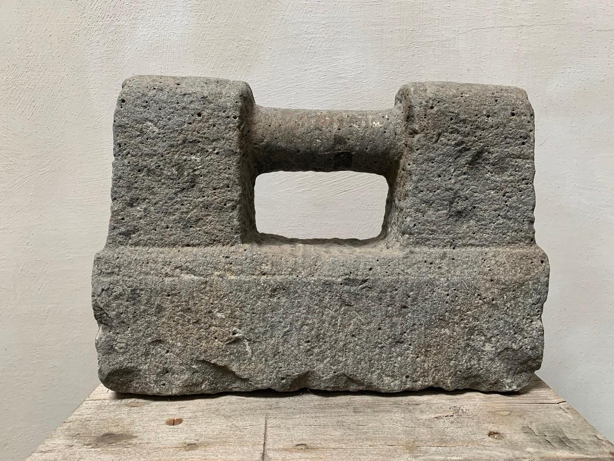 This double sided hitching post was used to stall horses for short period of times. They are found throughout China and made during centuries. This hardstone example dates from the 18th century and is sculpted from one block of solid granit. It has