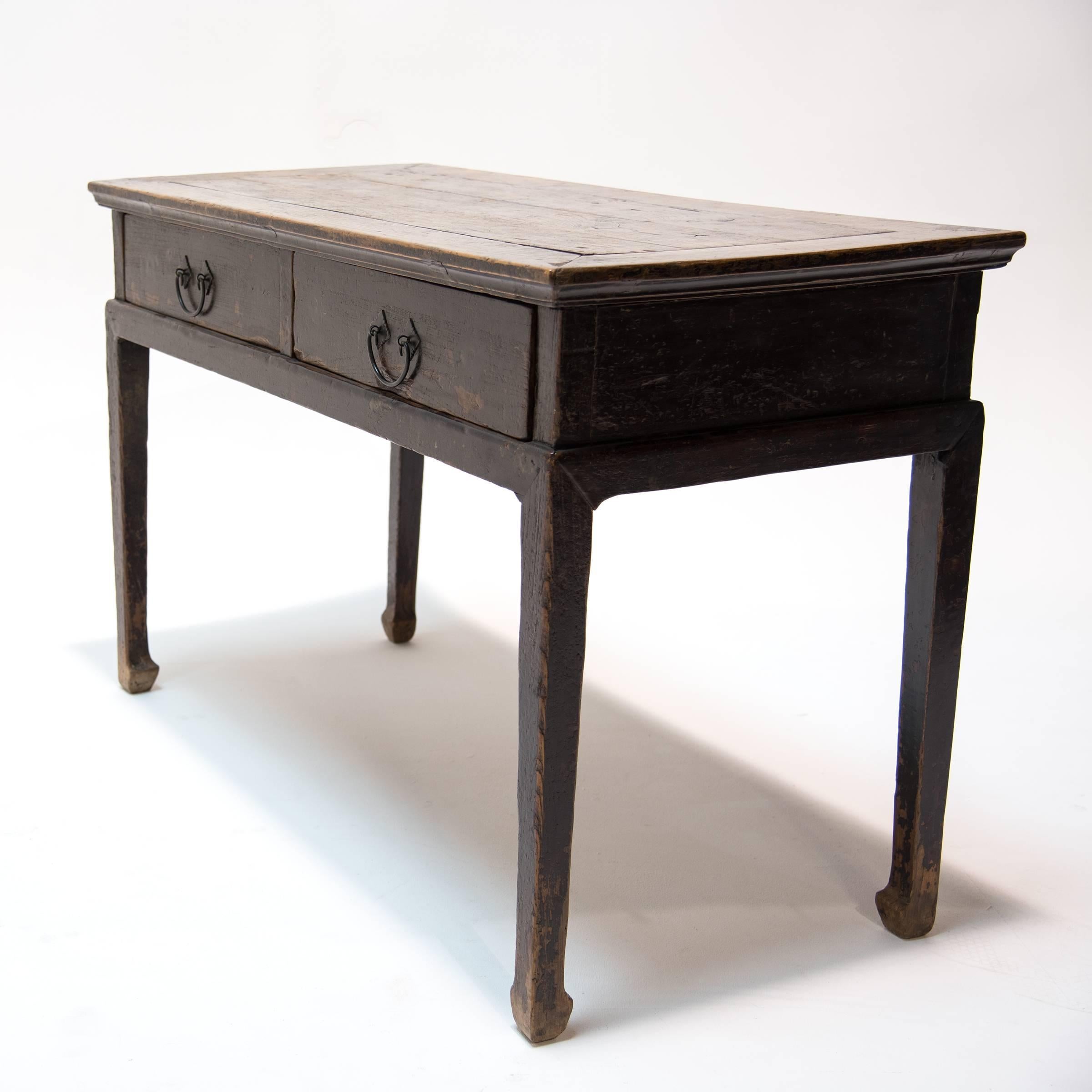 This finely crafted table from China’s Shanxi province was carved over two hundred years ago. The excellent proportions, concealed joinery, original hand forged hardware, and hoofed legs all have an austere beauty that belie the excellent