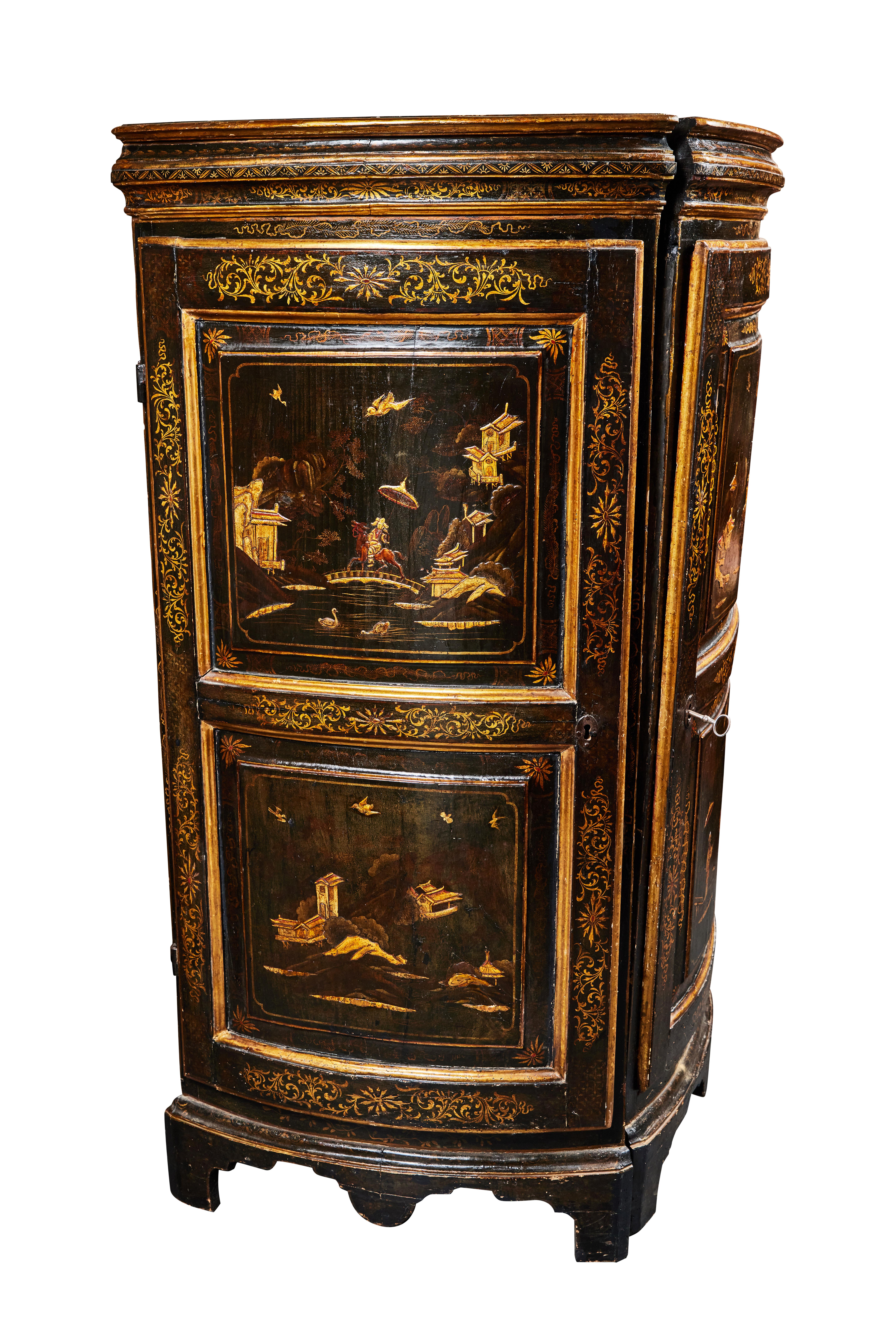 A pair of elegant, ebonized, lacquered, hand painted and parcel gilt, Chinoiserie decorated corner cabinets. Doors featuring two panels painted with unique scenes and embellished with foliate and floral details throughout.