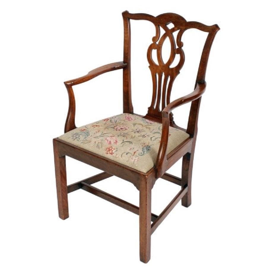 A late 18th century Georgian mahogany Chippendale elbow chair.

The chair has a shaped top rail with a broad pierced centre splat and a drop in pad seat.

The shaped arms have a flat surface for the elbow rests and a concave support.

The
