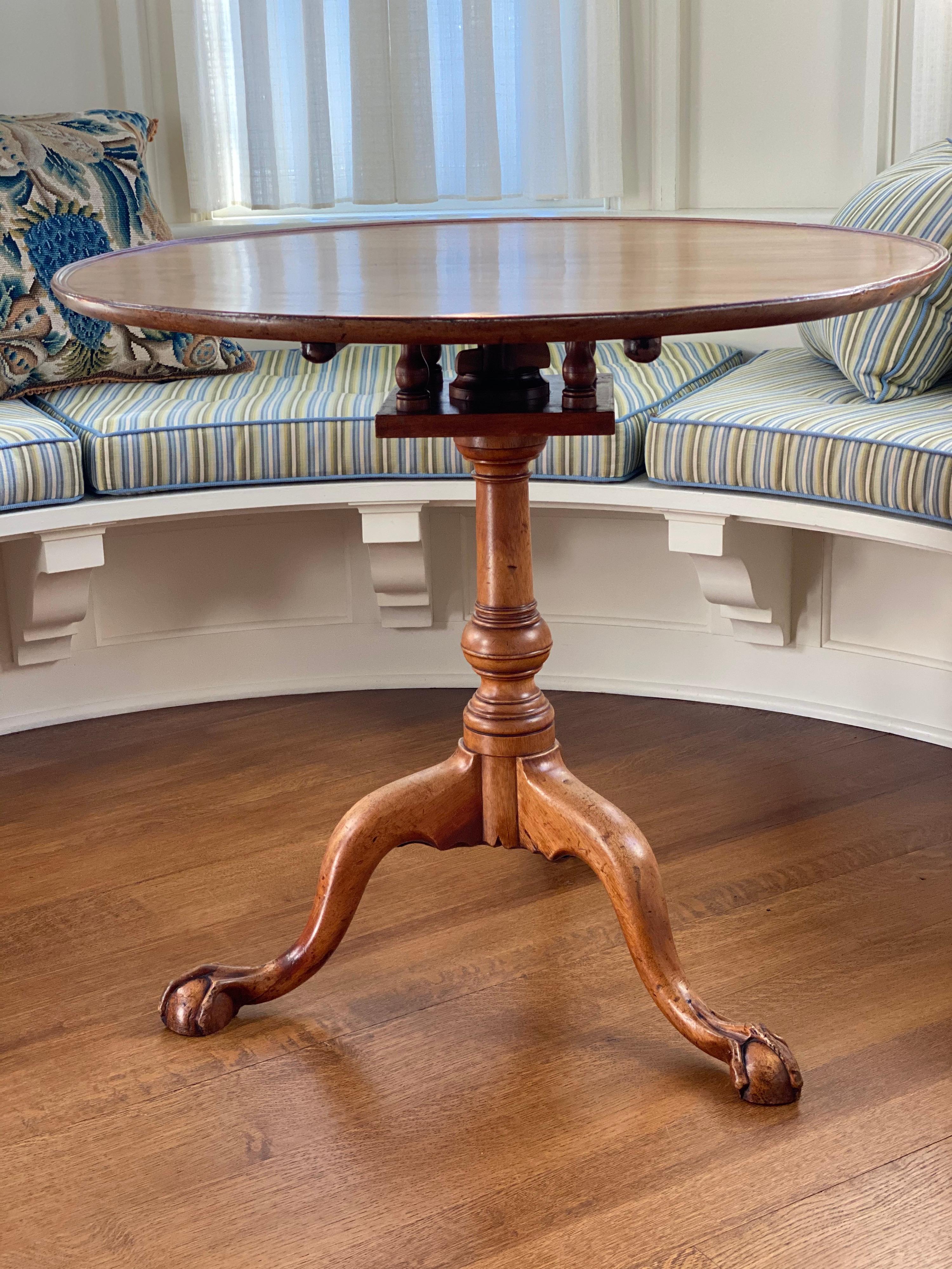 Chippendale figured mahogany dished tilt-top tea table, circa 1765
Squashed ball and claw foot, set on a 'birdcage'. Ring turned flattened or 'squashed' ball stem is supported by cabriole legs ending in boldly carved ball and claw