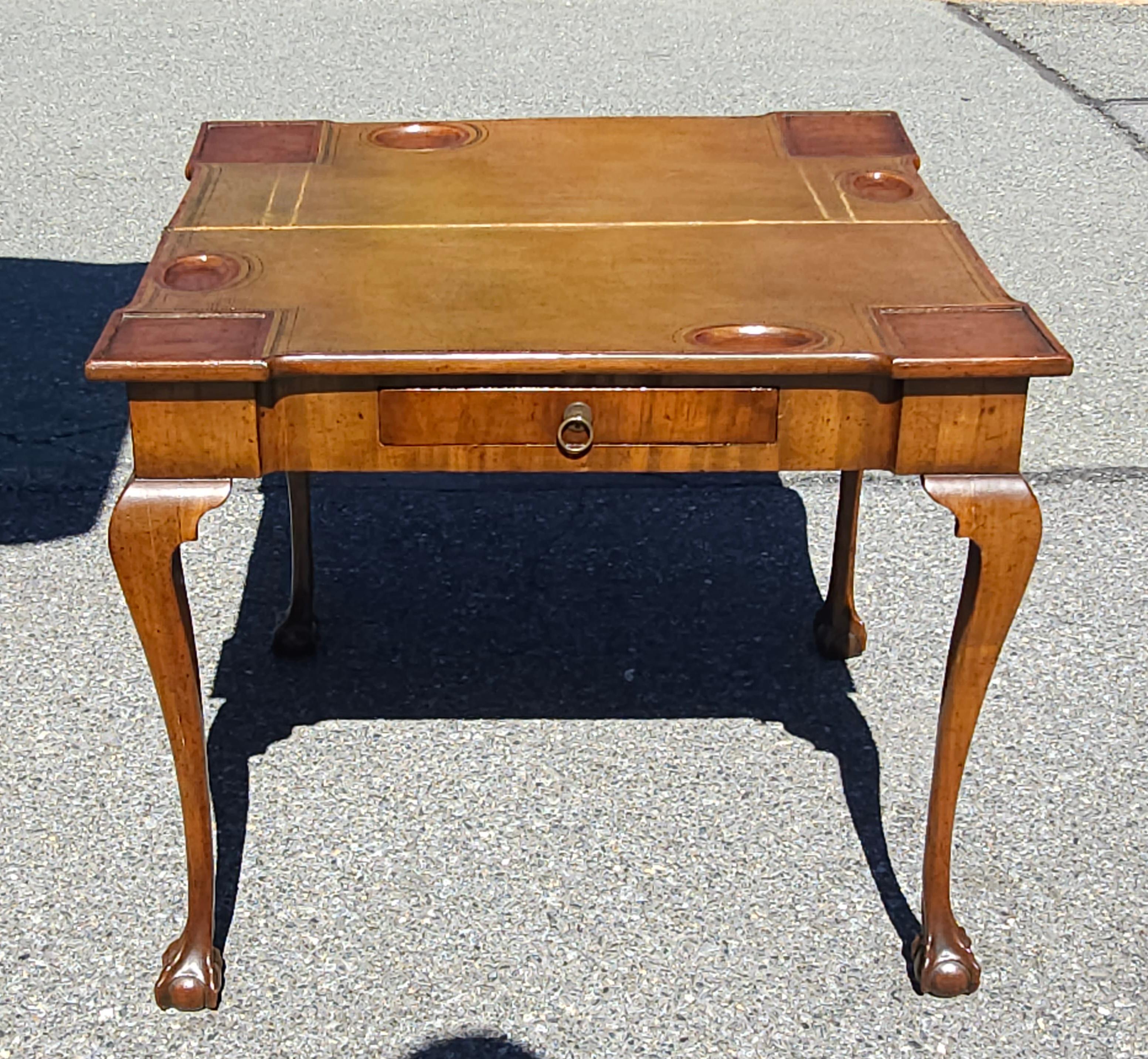 An 18th Century Chippendale Mahogany and Tooled Leather Fold Top Games Table  / console table with satinwood inlay, cabriole legs terminating with  ball and claw feet.
Measure 33