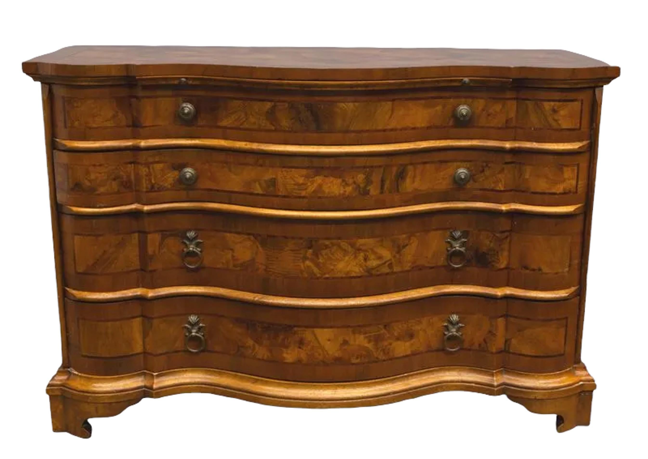 18th century (Circa 1750s) German oxbow shaped walnut commode with ash and fruitwood panels and inlay. The shaped top with three conforming drawers, standing on bun feet. High quality and incredible carving, one of the most expensive types of wood,