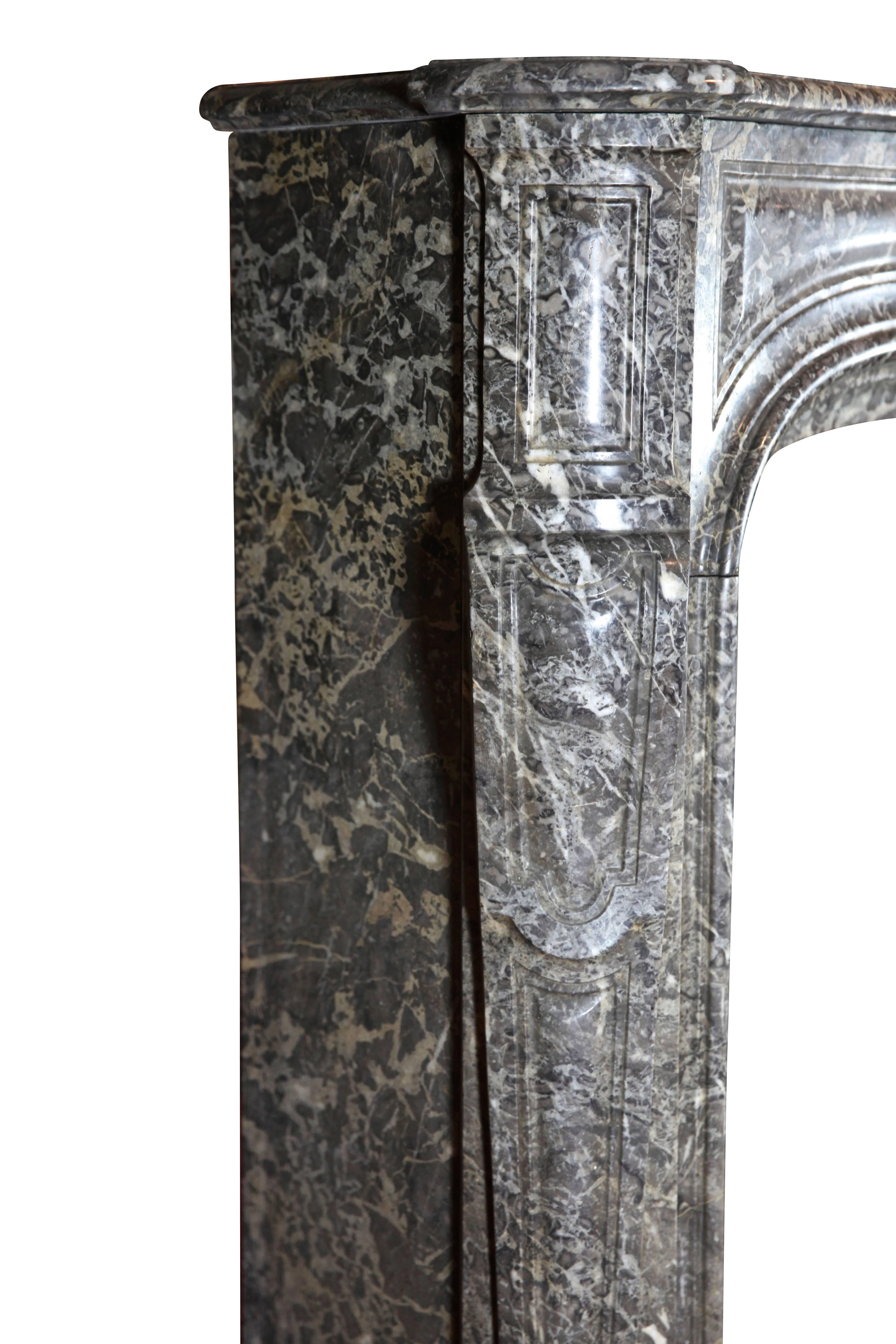 Strong 18th century Regency period antique fireplace surround in Belgian Gris St Anne Marble. This piece was originally installed in a paneled room in Mechelen, a city of historical significance in Belgium. 
Measures: 
190 cm EW 74,80