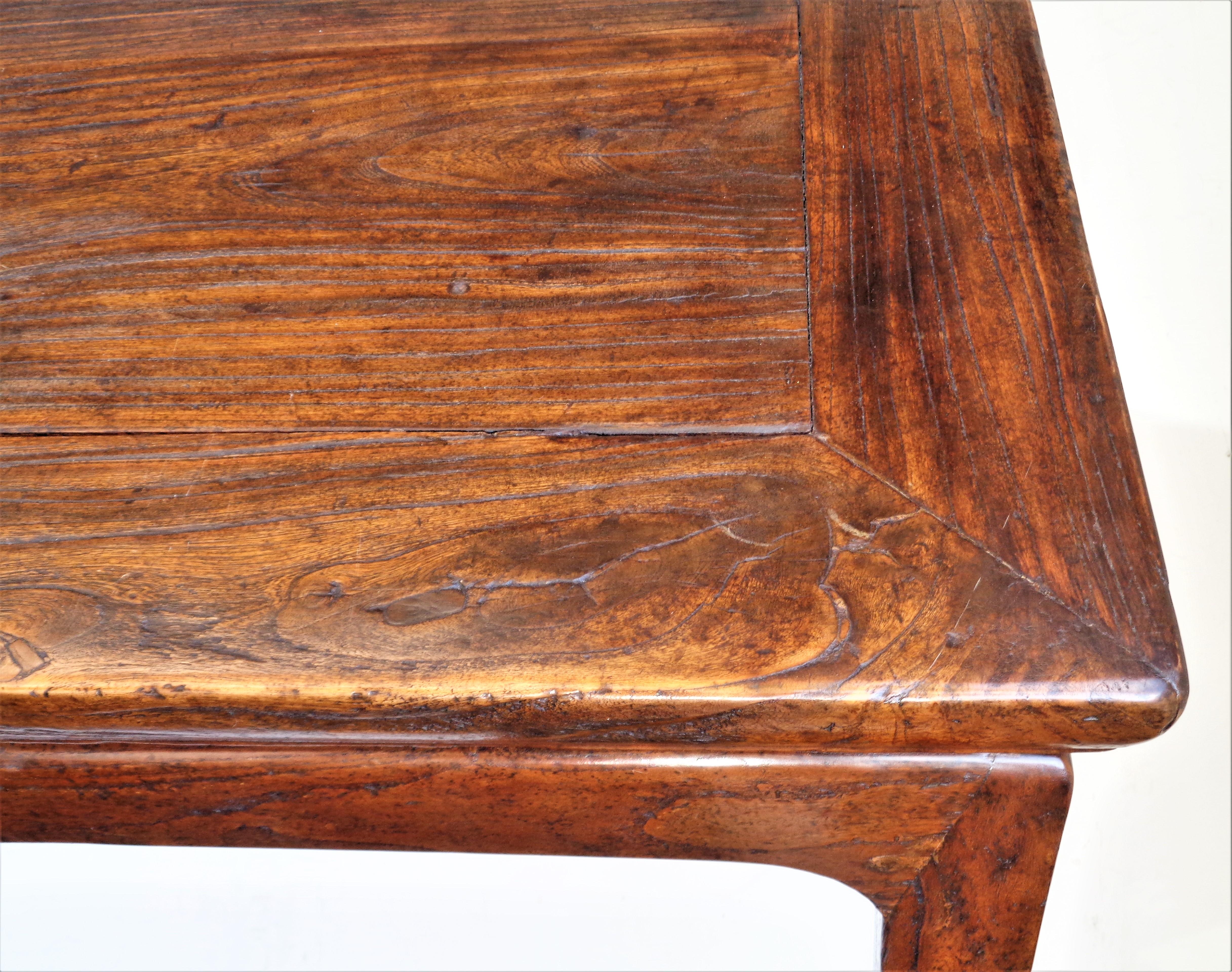 Antique 18th century Chinese Yumu ( northern elm wood ) table with early mortise tenon and mitered construction, floating skirted top and modified hoof feet. Overall beautifully aged original old surface color with strong figuring to wood. An