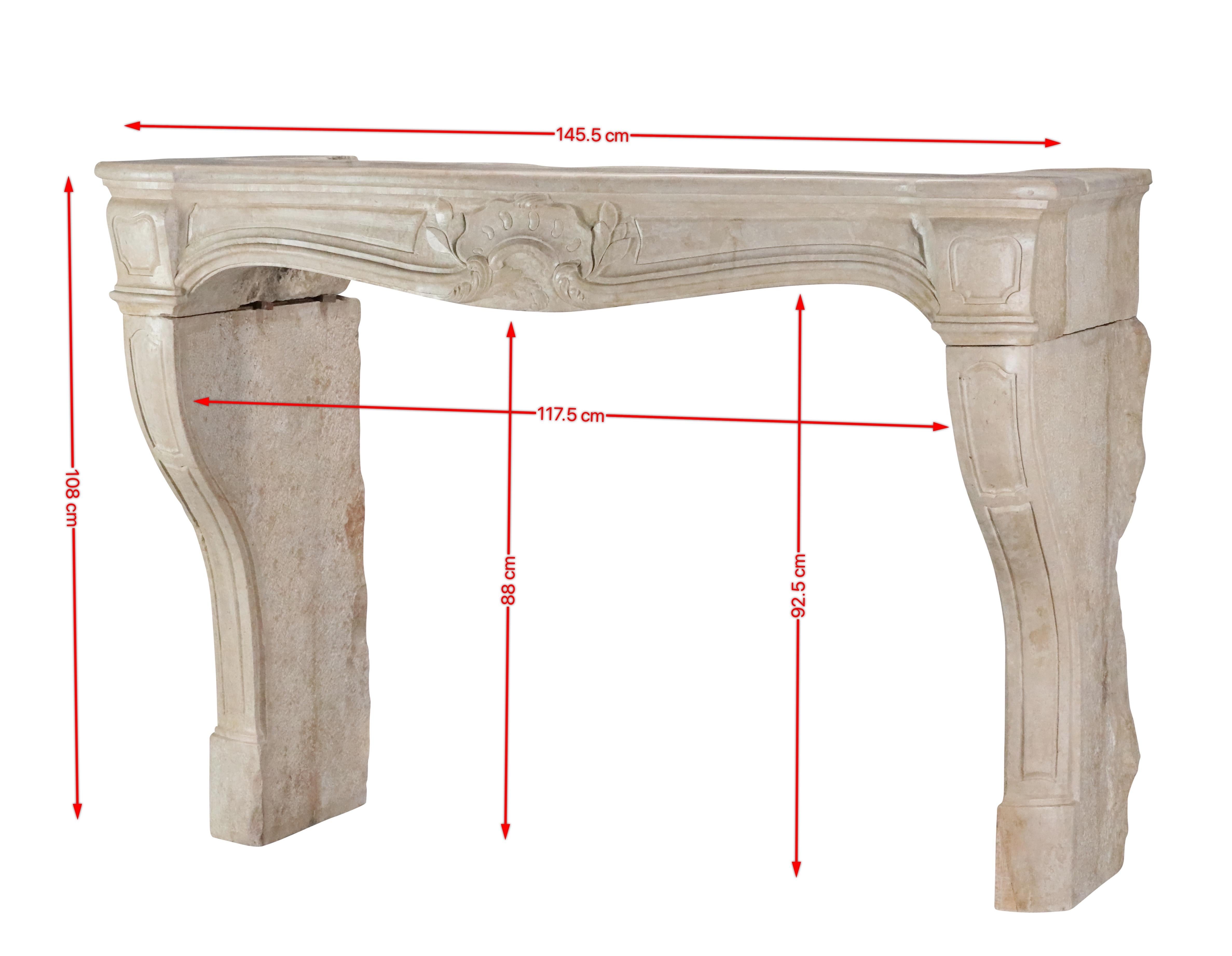 Classic French antique fireplace surround from the 18th century period. The limestone is waxed. This regency period decorative chimneypiece creates original interior design. Fine carving and small in proportions. An exclusive piece for an authentic