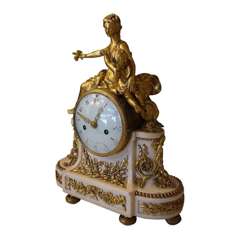 A late 18th century Louis XVI pendulum Parisian clock in good condition. Designed and produced by Jean Baptiste Andre Furet. Ormolu-mounted white marble mantle clock and marble base with gilded bronze decoration. Complete with a bell and suitable