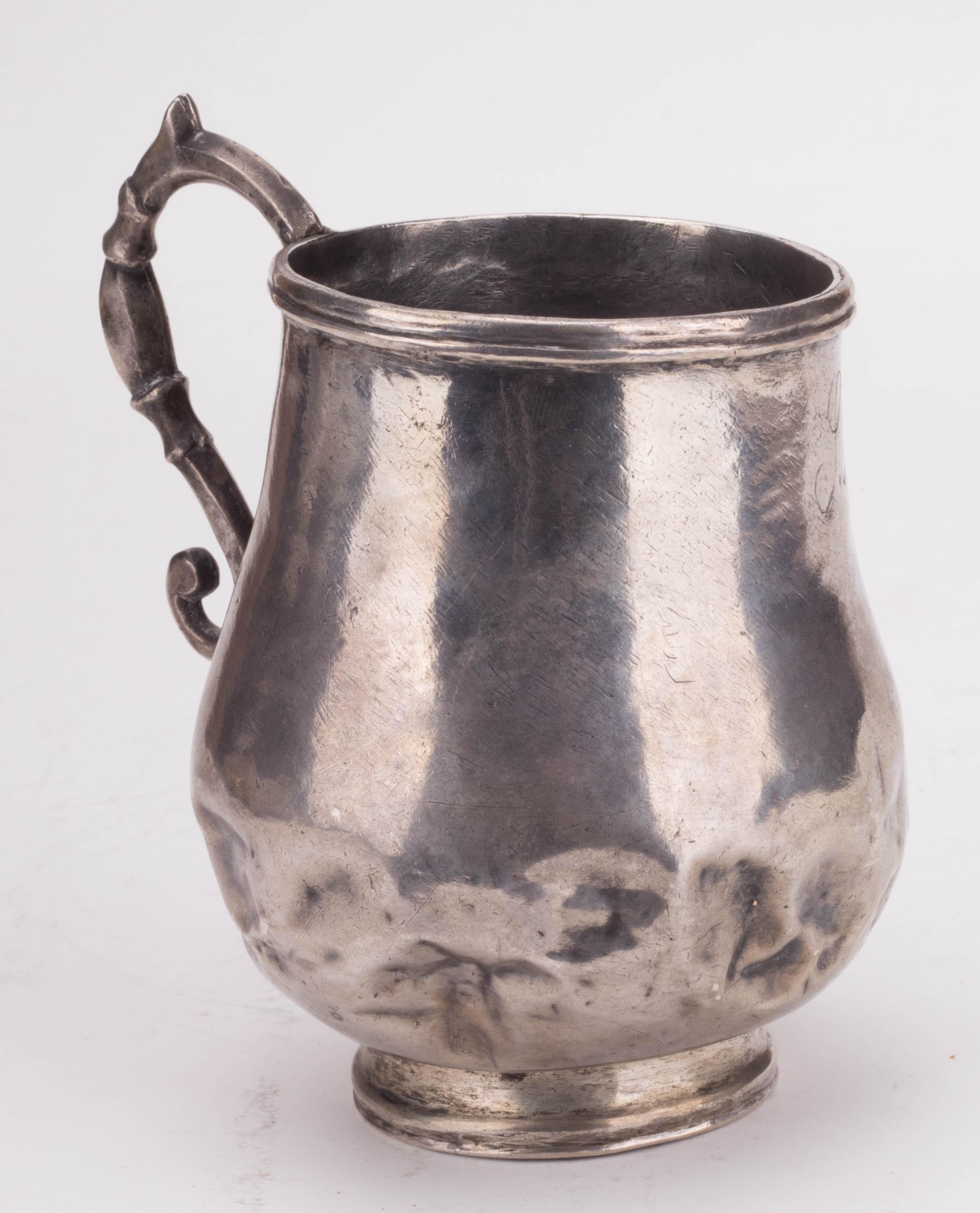 18th century colonial silver dented jug with engraved initials.

Silver by weight: 295g.