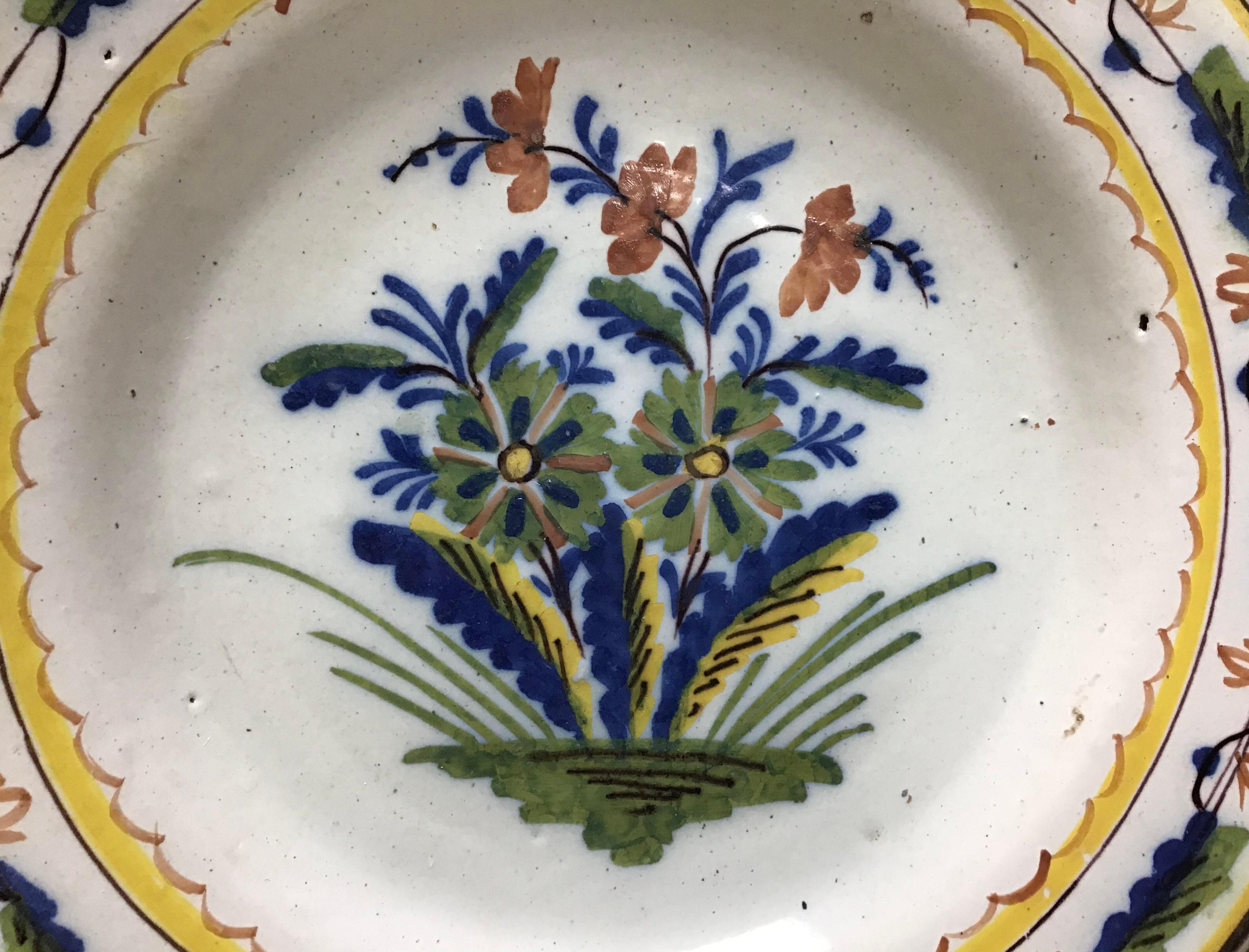 18th Century Dutch delft polychromed plate. The plate is very vibrant with multi colors and decorated with foliage/ flowers and ornate boarders. There has been a chips at some stage to the rim. The overall condition of the plate is very good, a