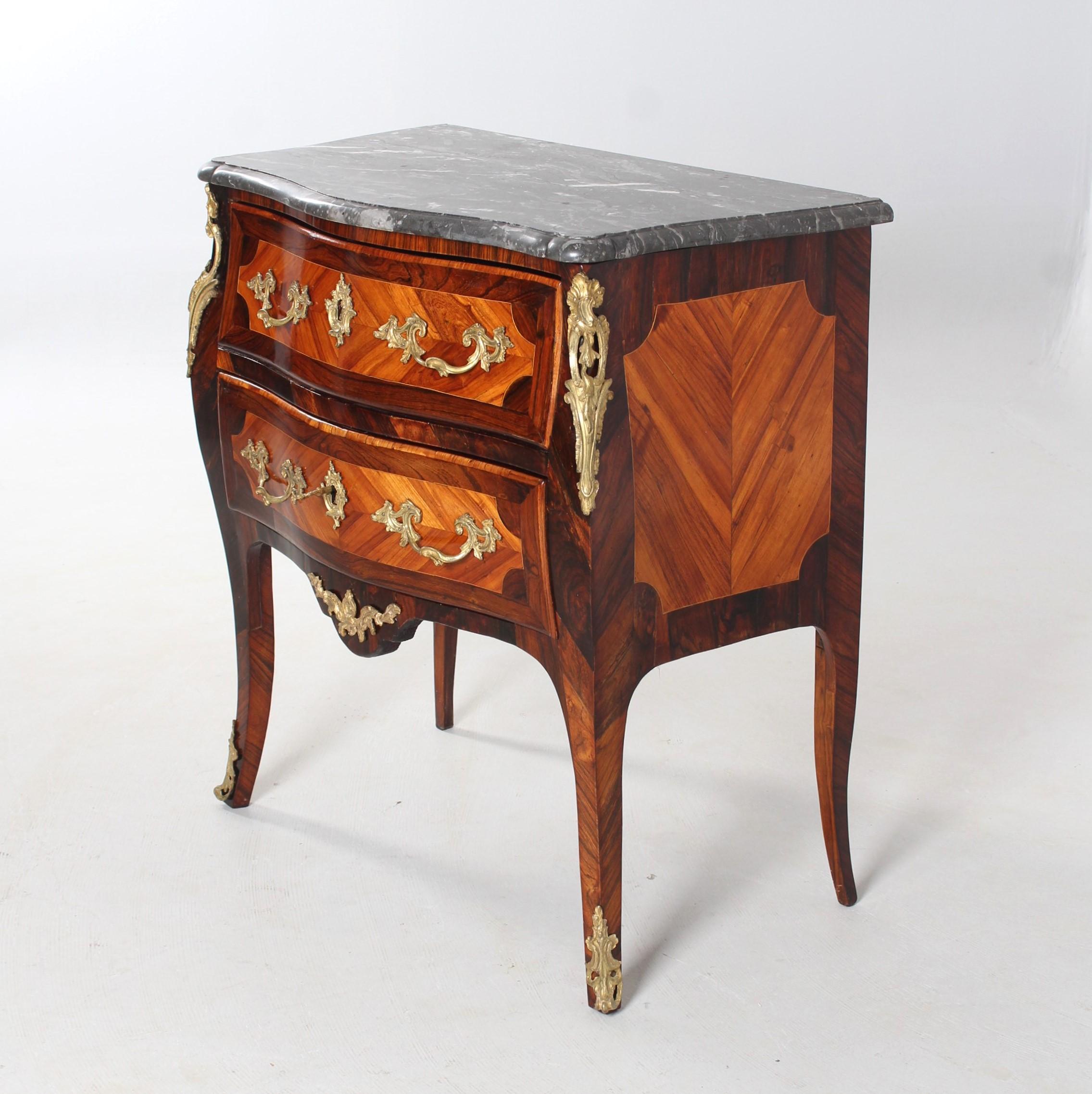 Small Louis XV Commode, so called Commode Sauteuse

France (Paris)
Rosewood
around 1760

Dimensions: with marble top H x W x D: 85 x 80 x 46 cm

Description:
Two-storey piece of furniture standing on slightly flared legs. The relatively long legs
